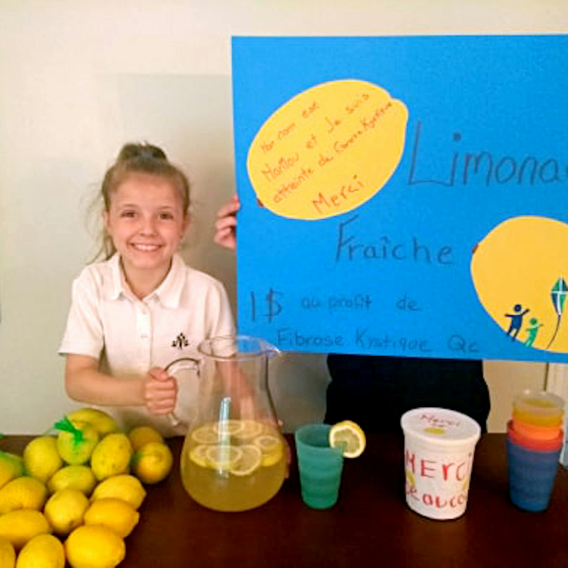 A young girl fundraises at a lemonade stand