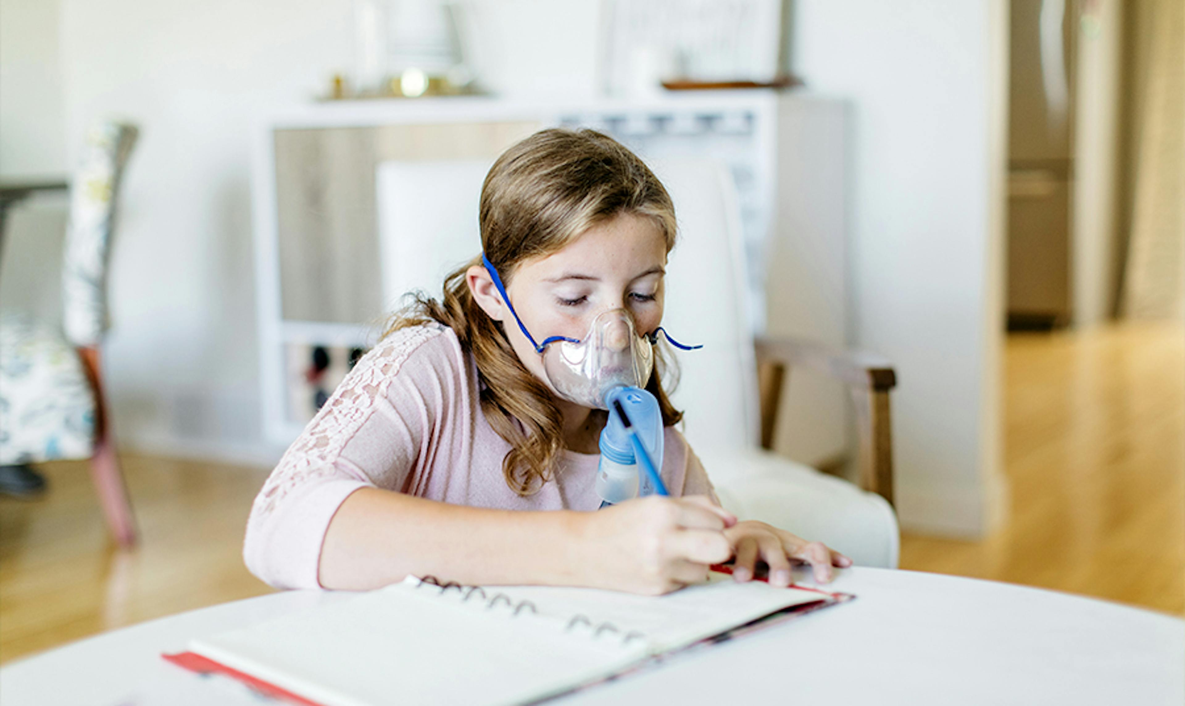 Young girl with CF uses a breathing apparatus