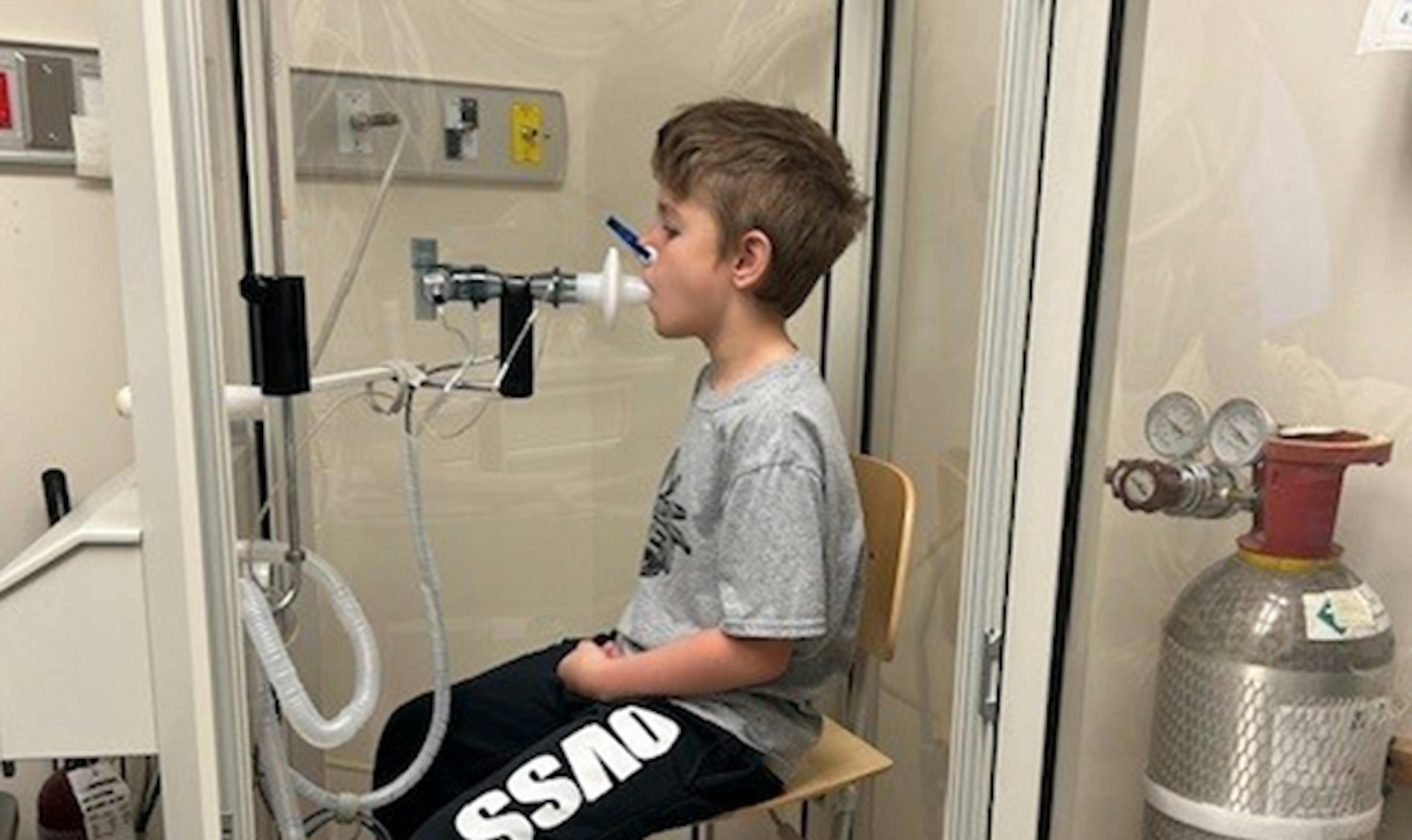 Young boy takes breathing test in CF clinic