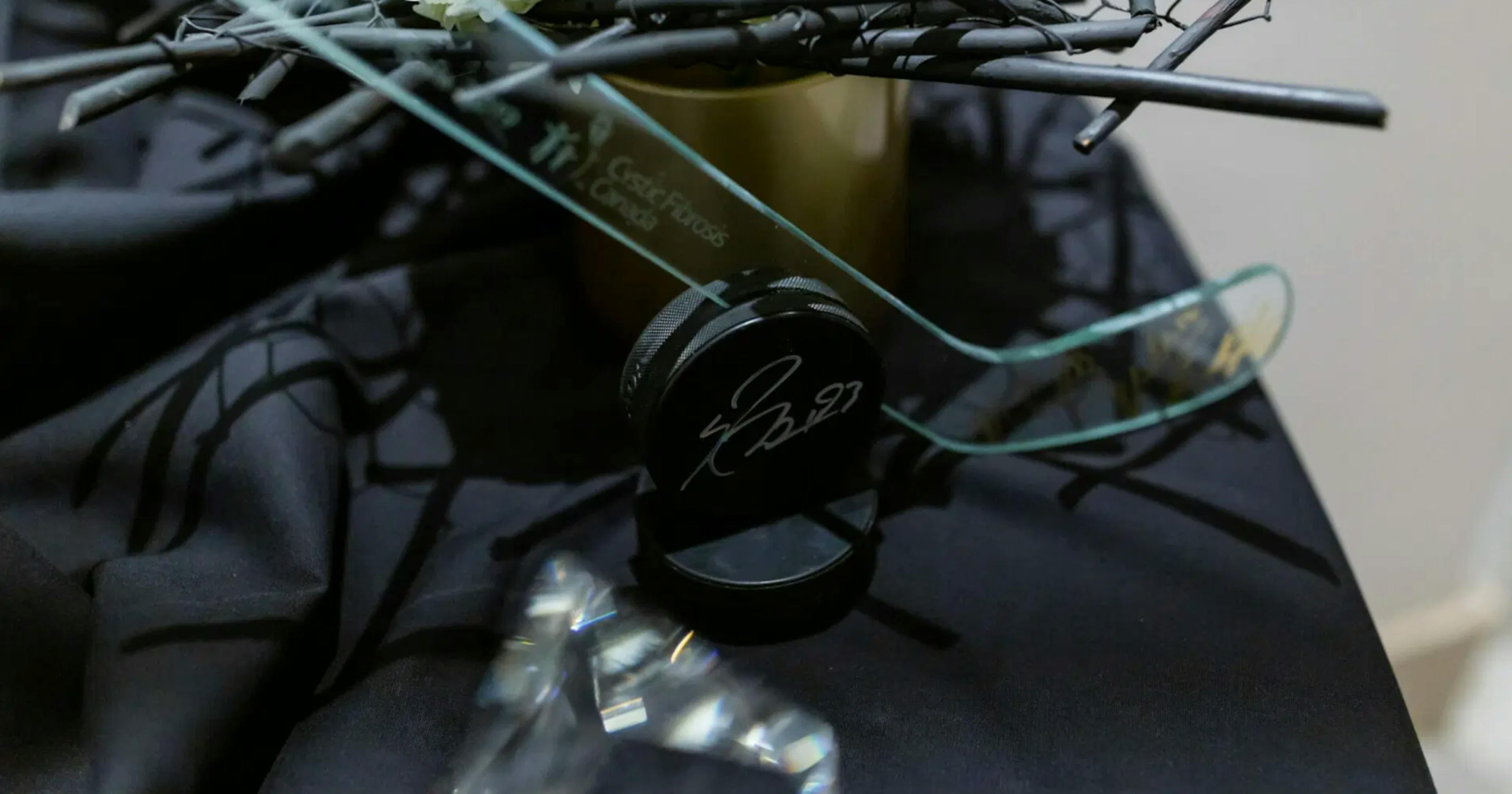 Gala table with black tablecloth and glass hockey stick and puck