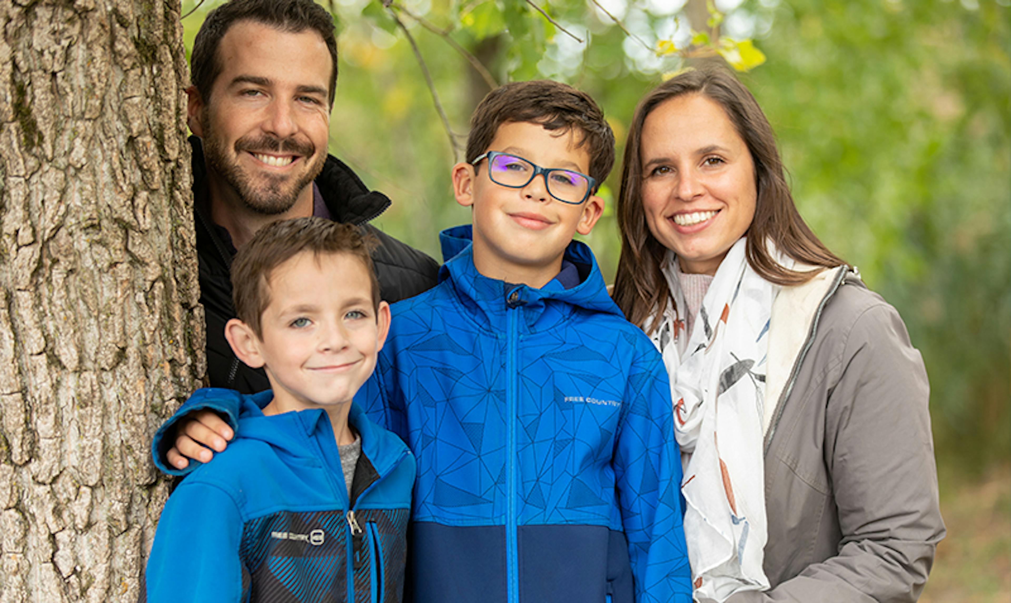 a family stands together outside