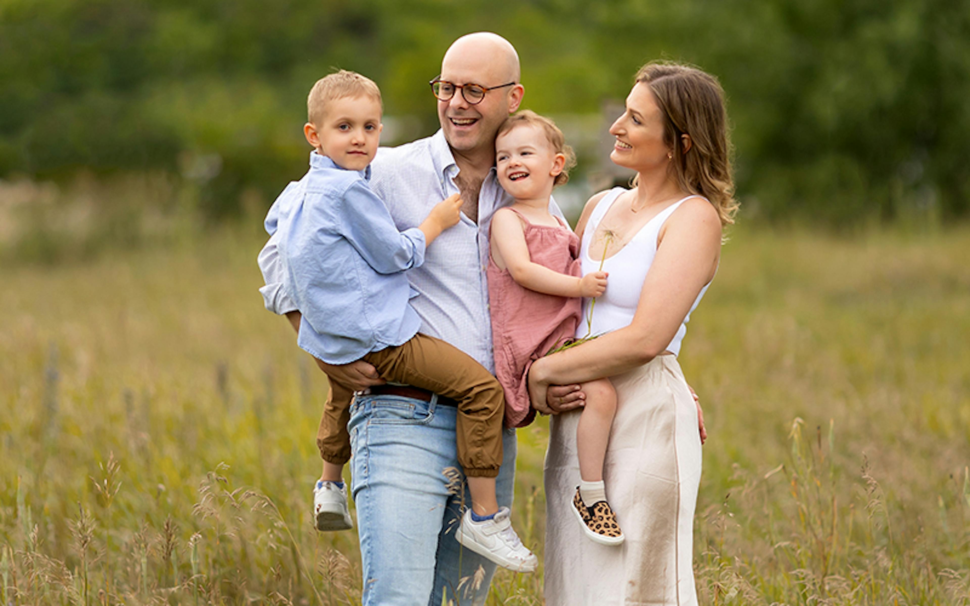 The Clair family outside in a field for a family portrait