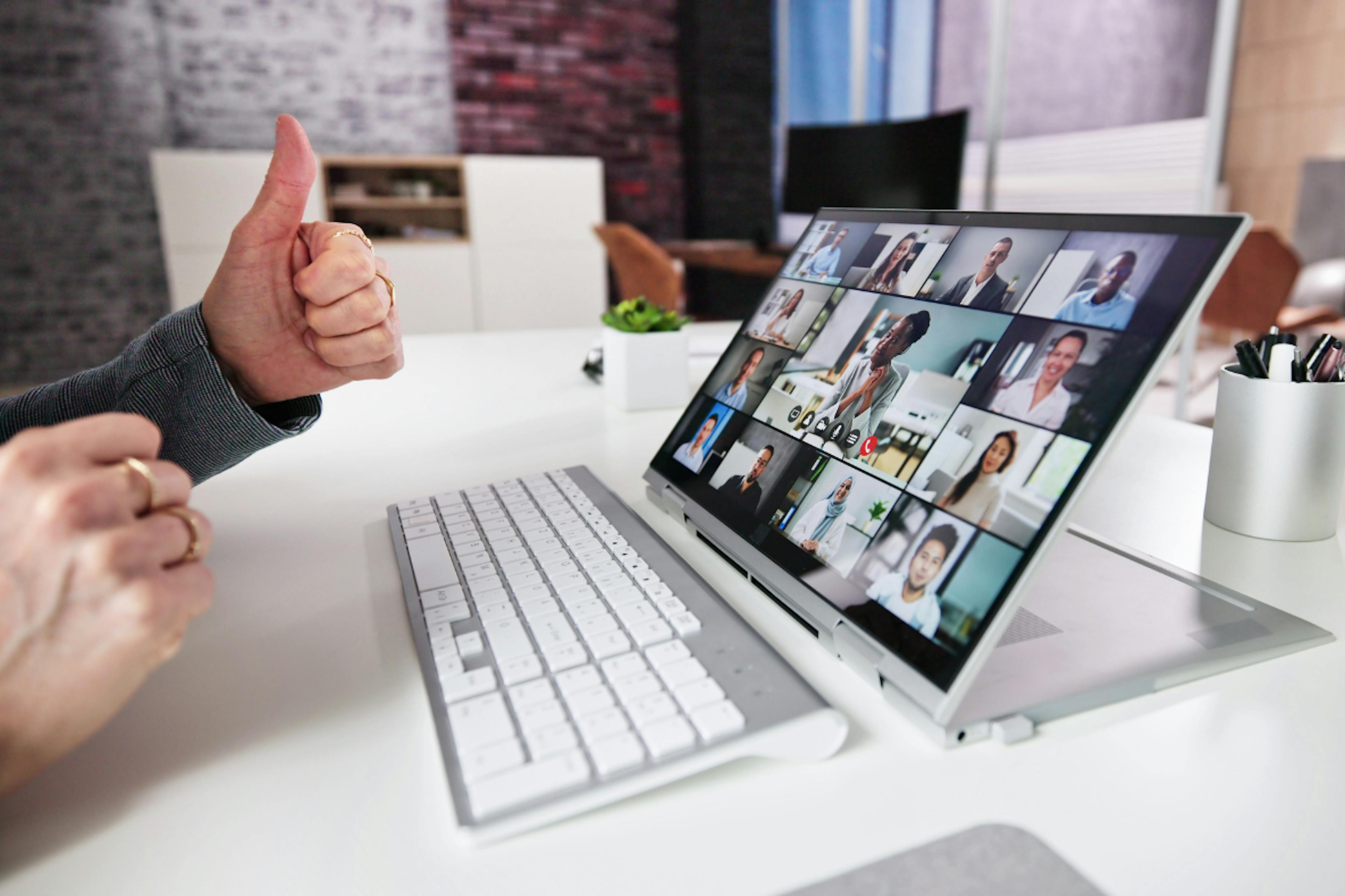 A computer showing a group meeting online. 