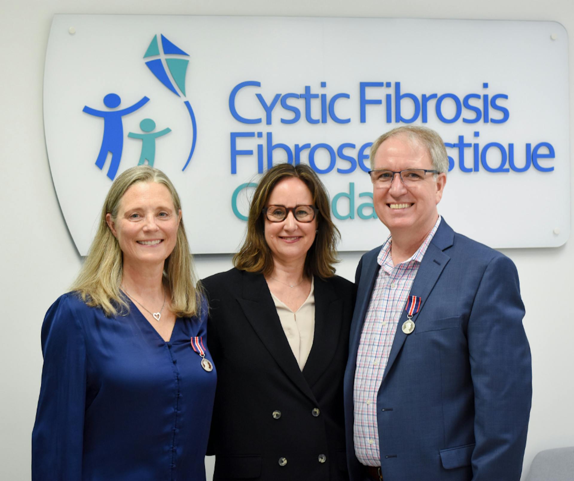 CEO Kelly Grover poses with Ron Anderson and Nancy Kotush