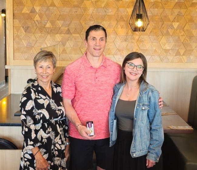 Rod Brind'Amour accepts his King Charles III Coronation Medal from Chris Black and Kim Wood
