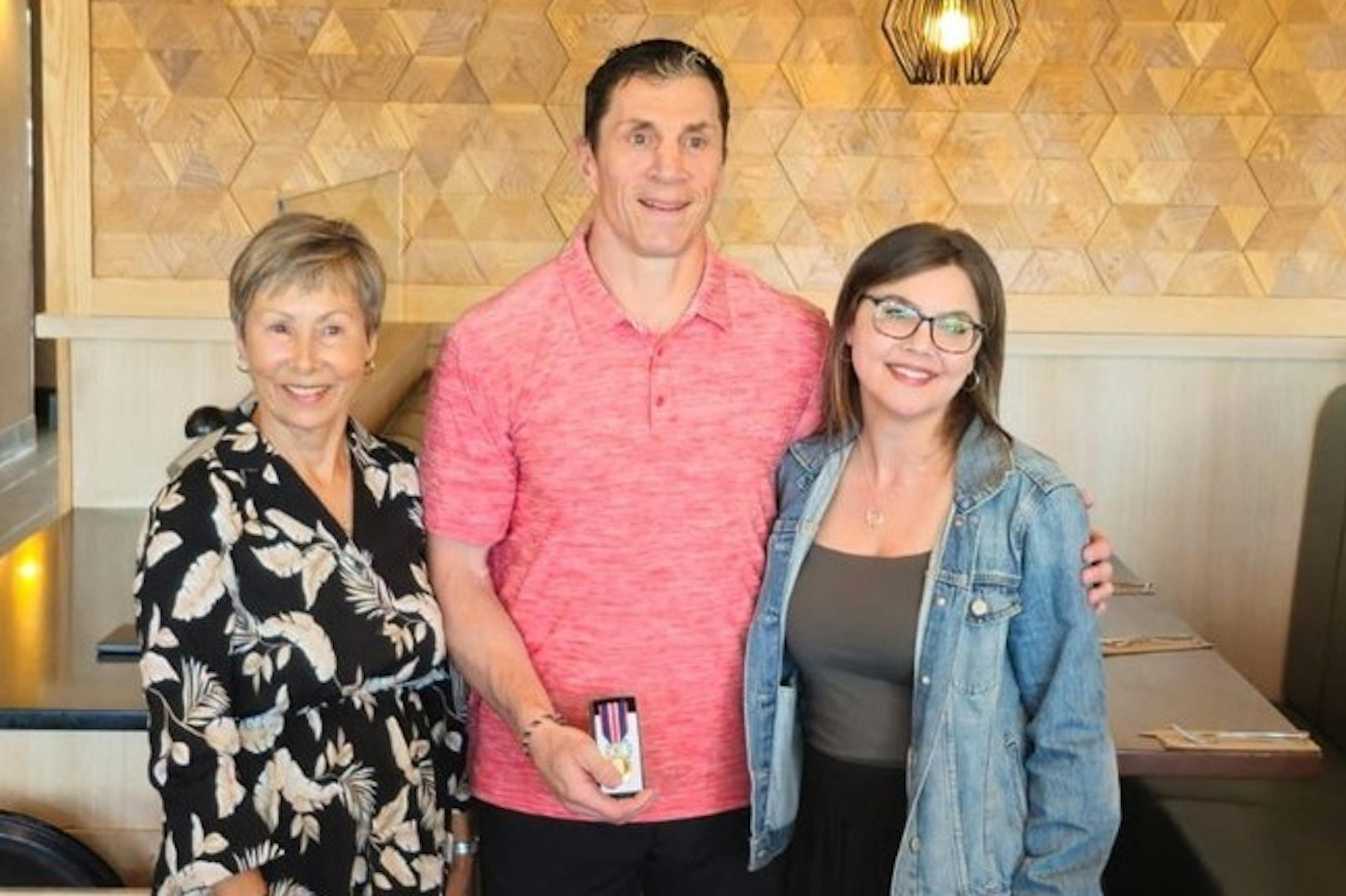 Rod Brind'Amour accepts his King Charles III Coronation Medal from Chris Black and Kim Wood