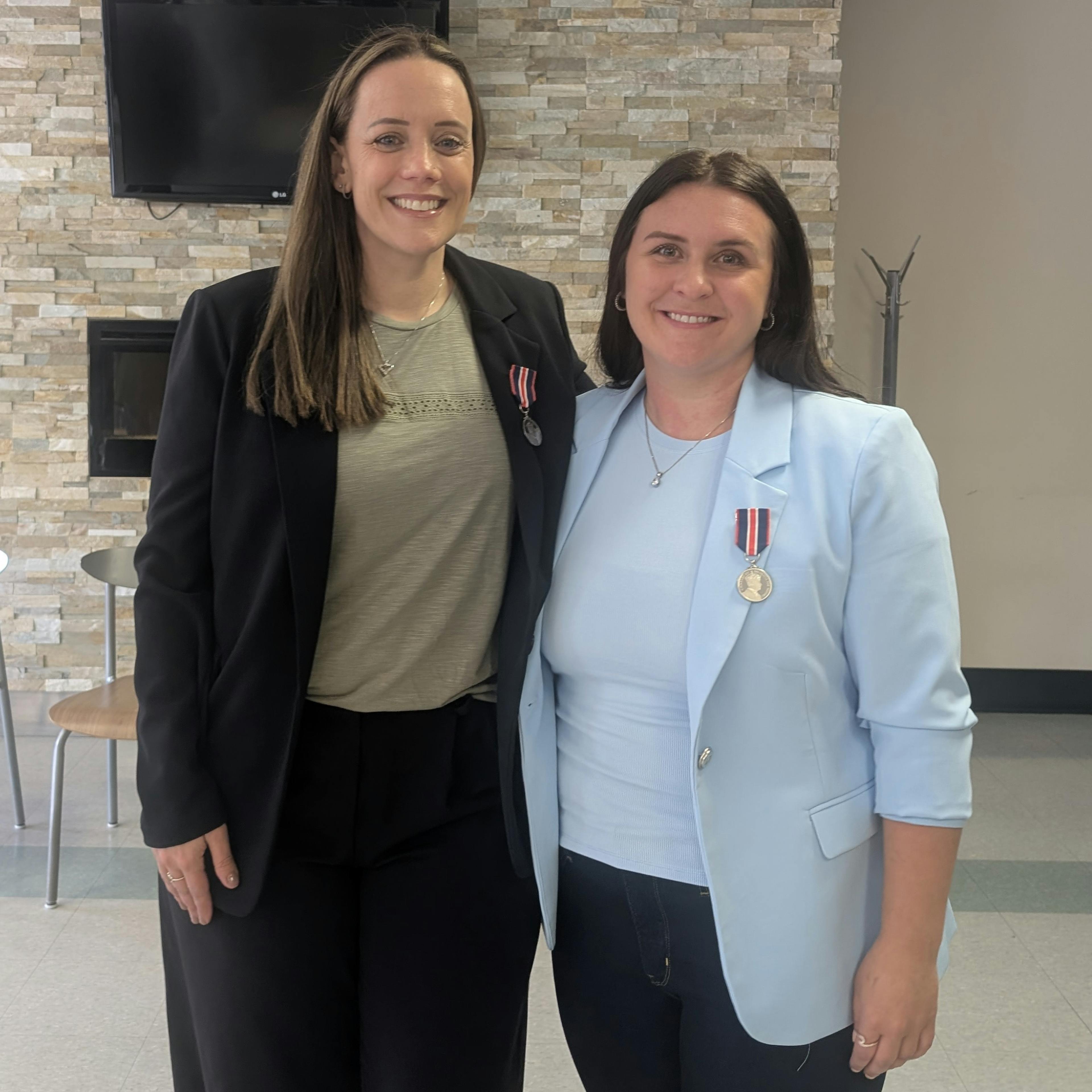 Paige Trudeau-Shemilt and Marcina Perron accept their King Charles III Coronation medal 