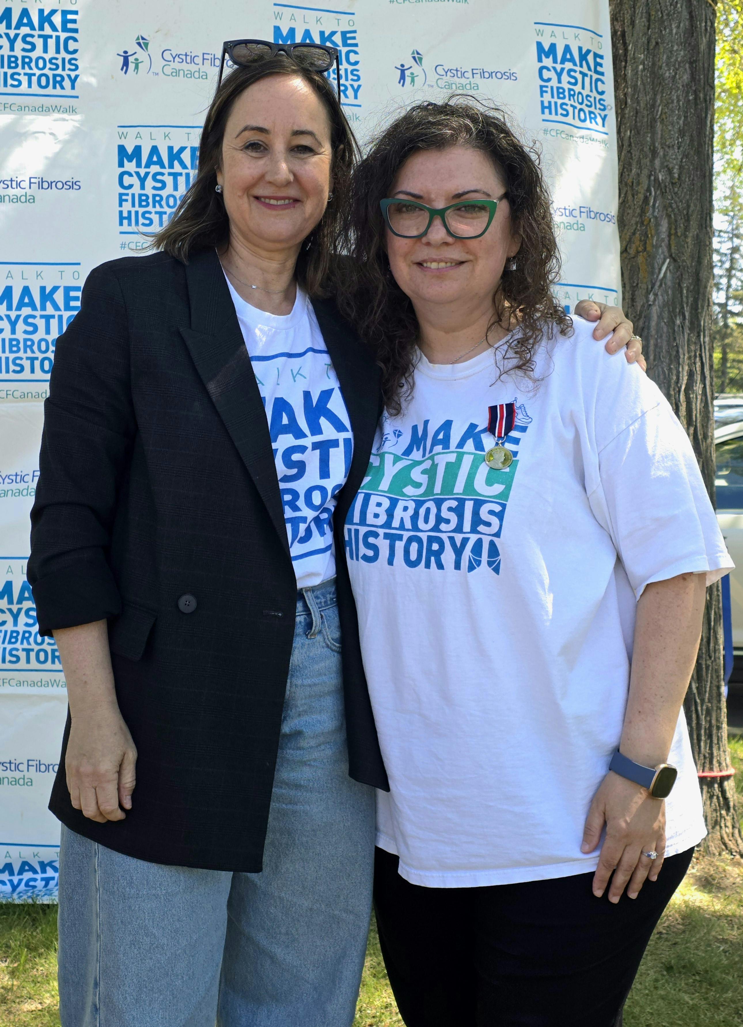 Twyla McDougall accepts the King Charles III Coronation Medal from Kelly Grover