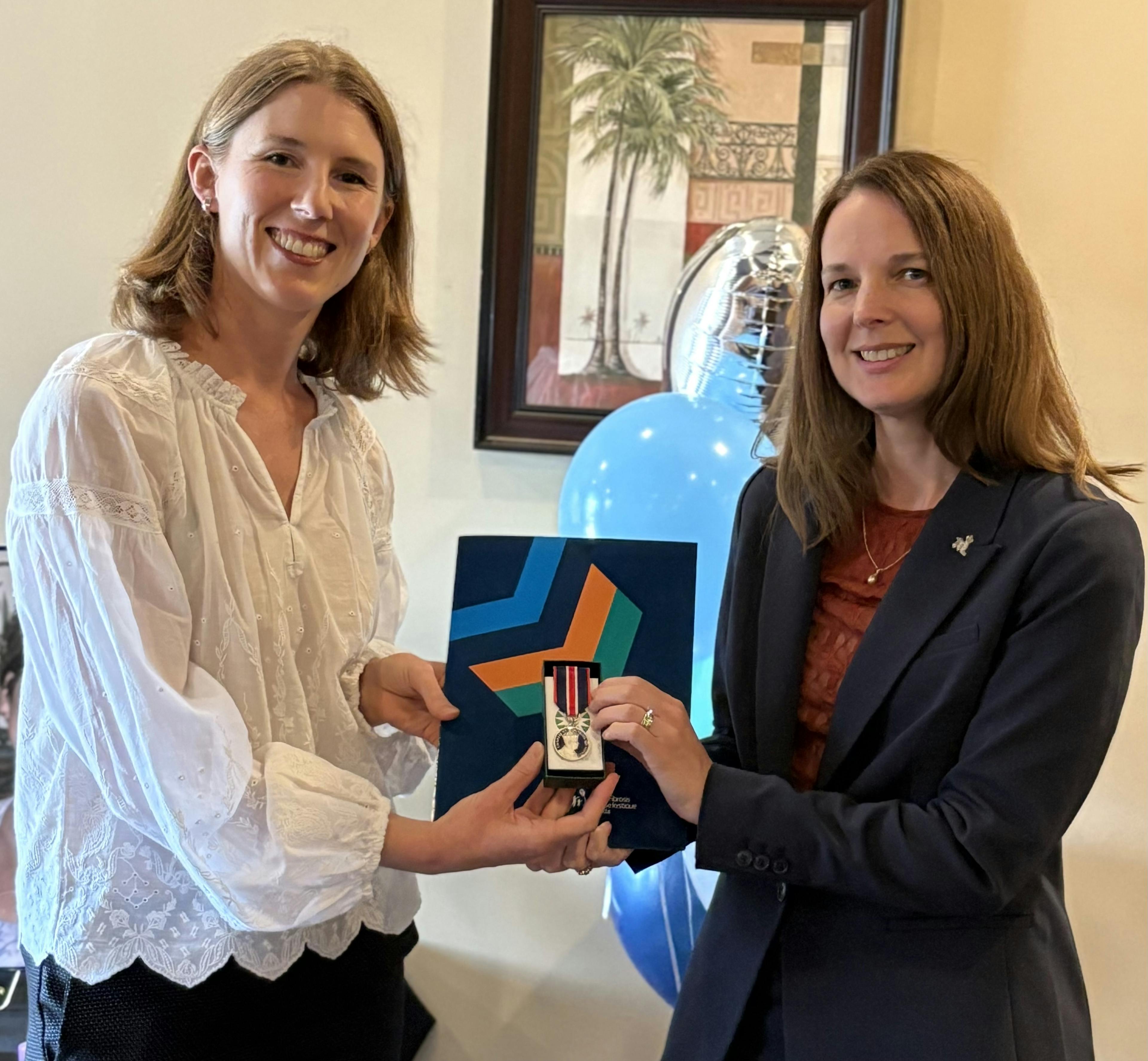 Aisha Champness presents the KCCM to Caroline Rigutto 