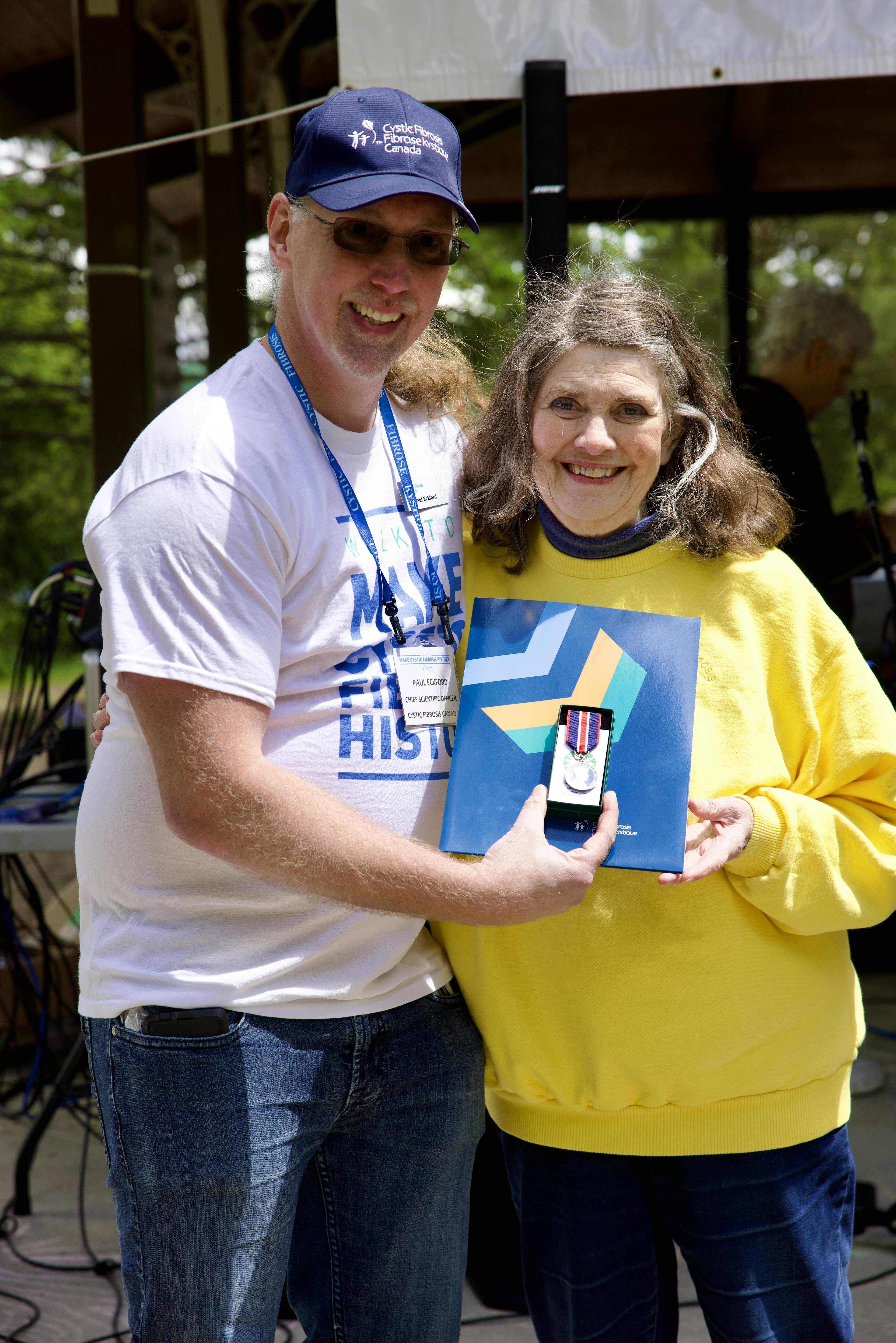 ren McCulloch accepts the King Charles  III Coronation Medal from Dr. Paul Eckford. 