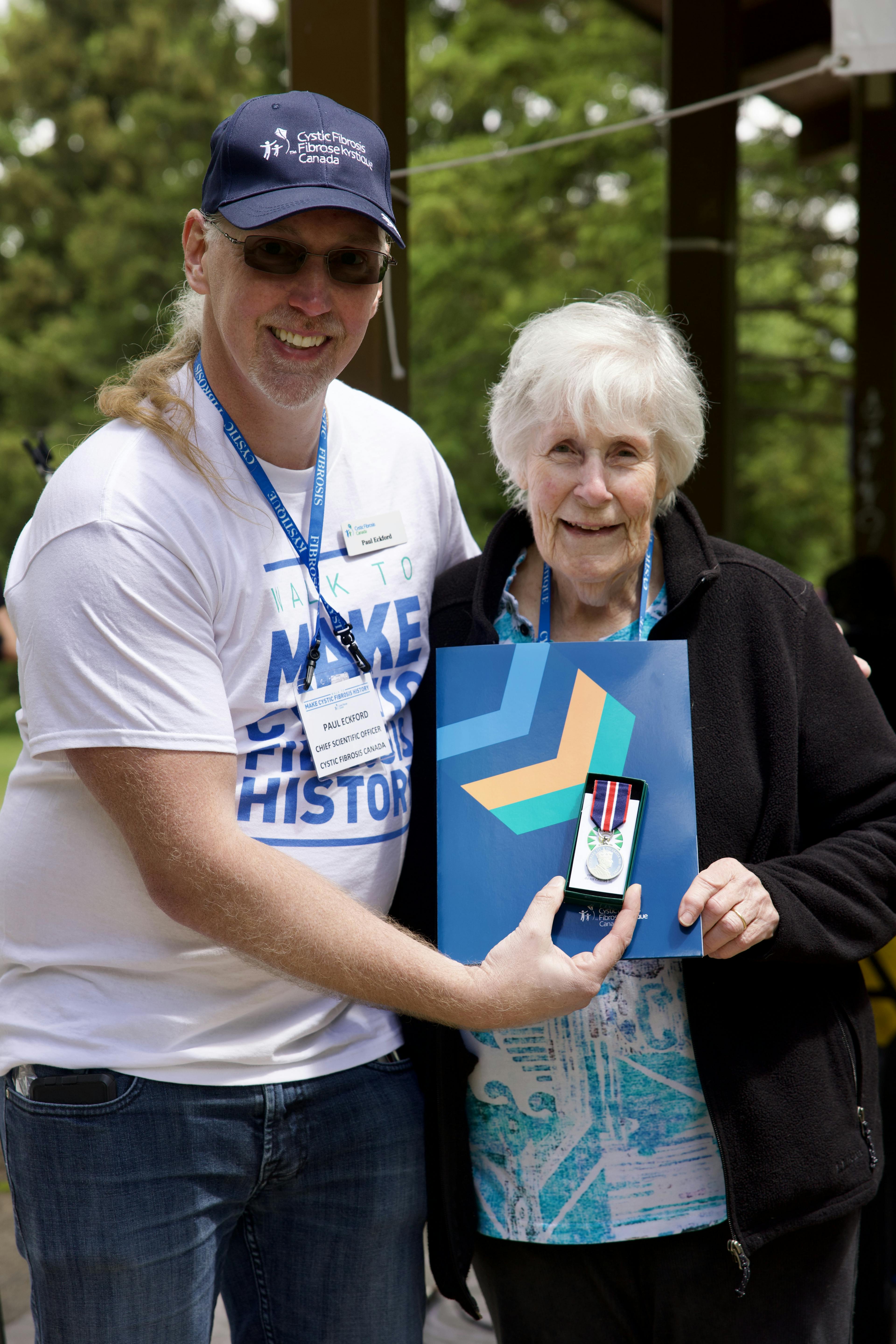 Dr. Paul Eckford presents Elizabeth Graham with a King Charles III Coronation Medal 