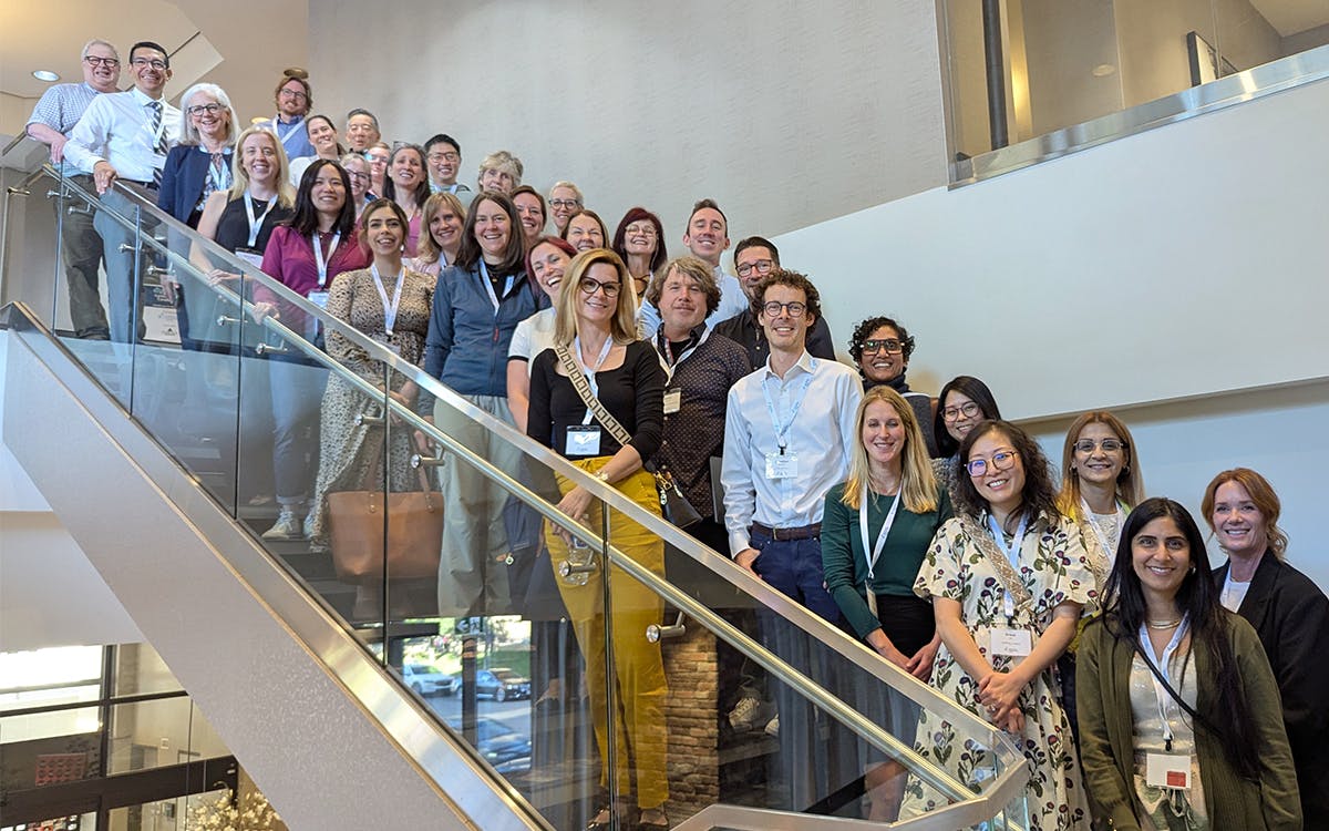 A large group of CF Conference attendees gather on the steps of the conference ballroom in Calgary.