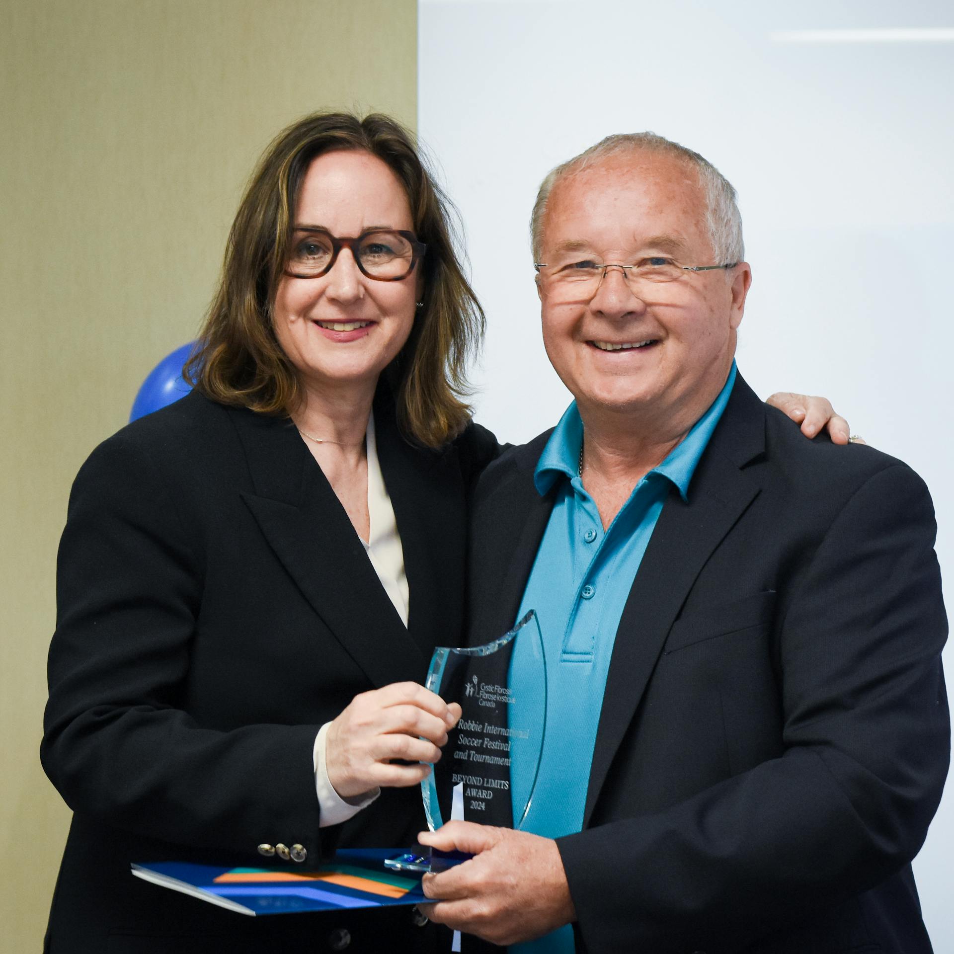 Kelly Grover, CEO awarding community member with award