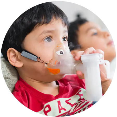 A young boy using his nebulizer for CF treatment.