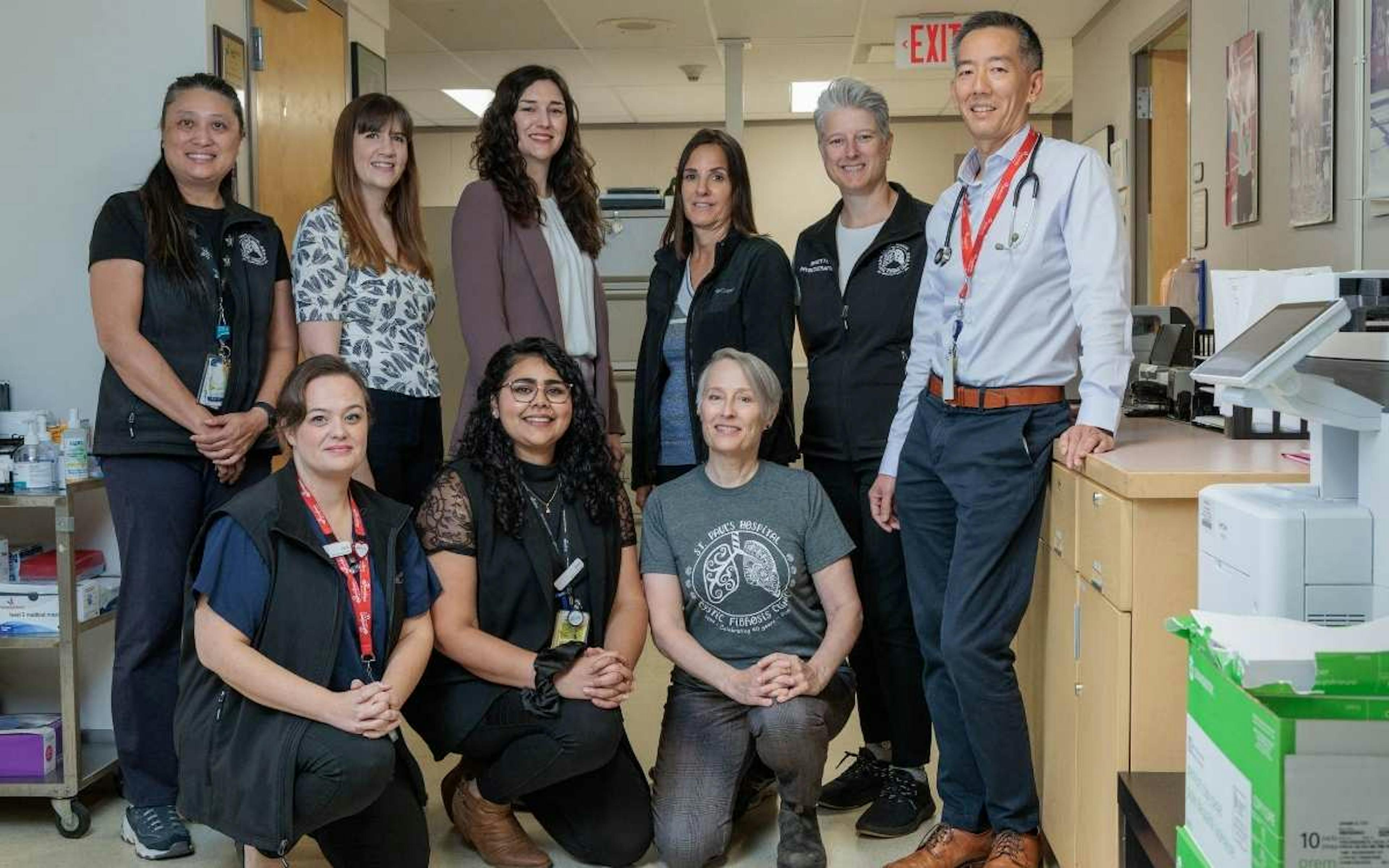 A group of employees posing for a photo at a hospital.