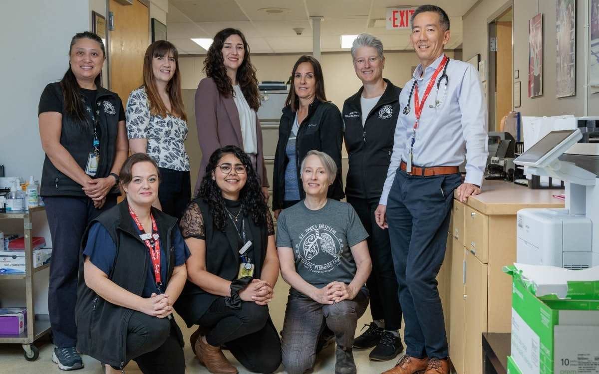 A group of employees posing for a photo at a hospital.