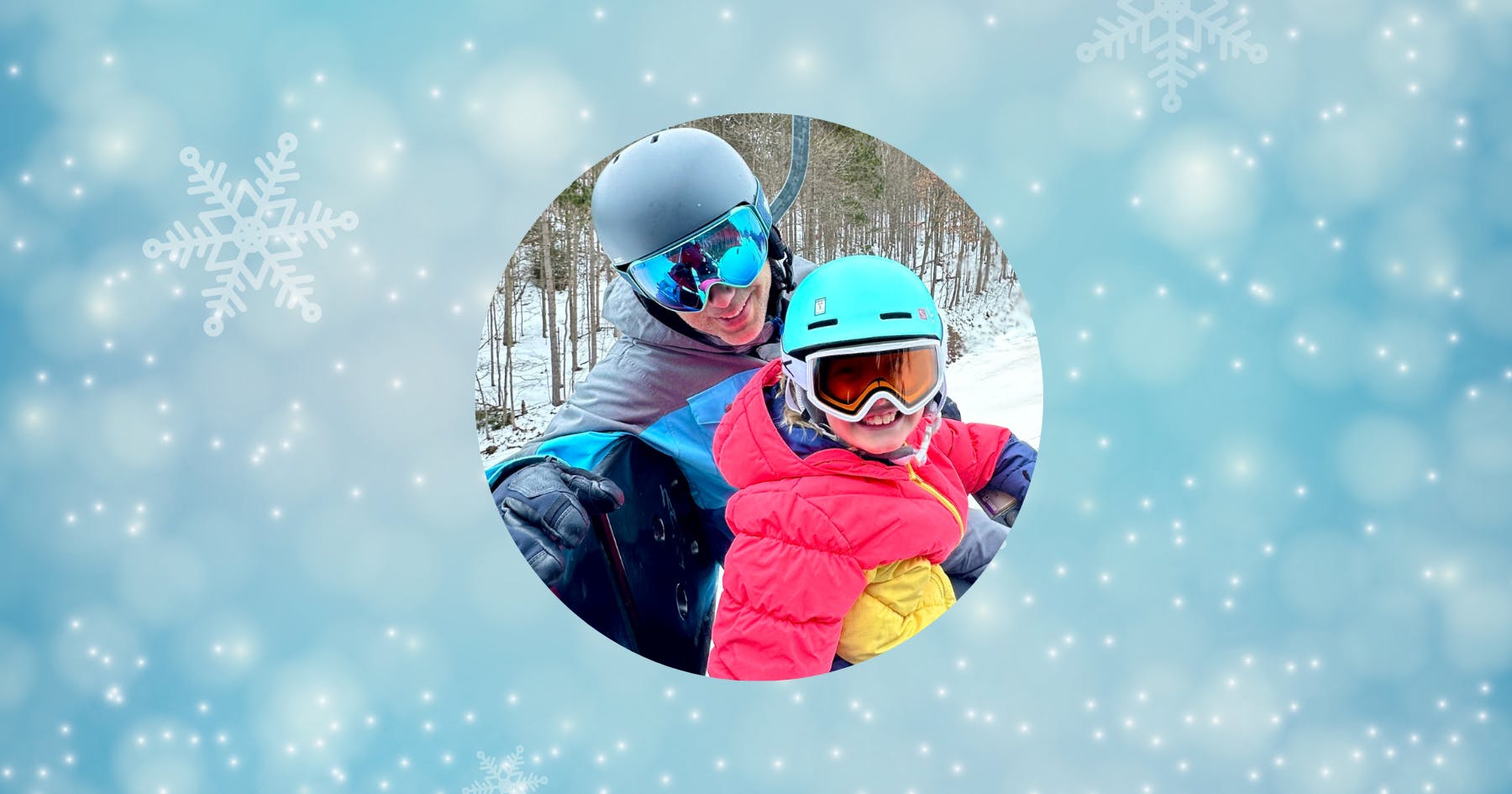 A father and daughter ride the ski lift on a winter day