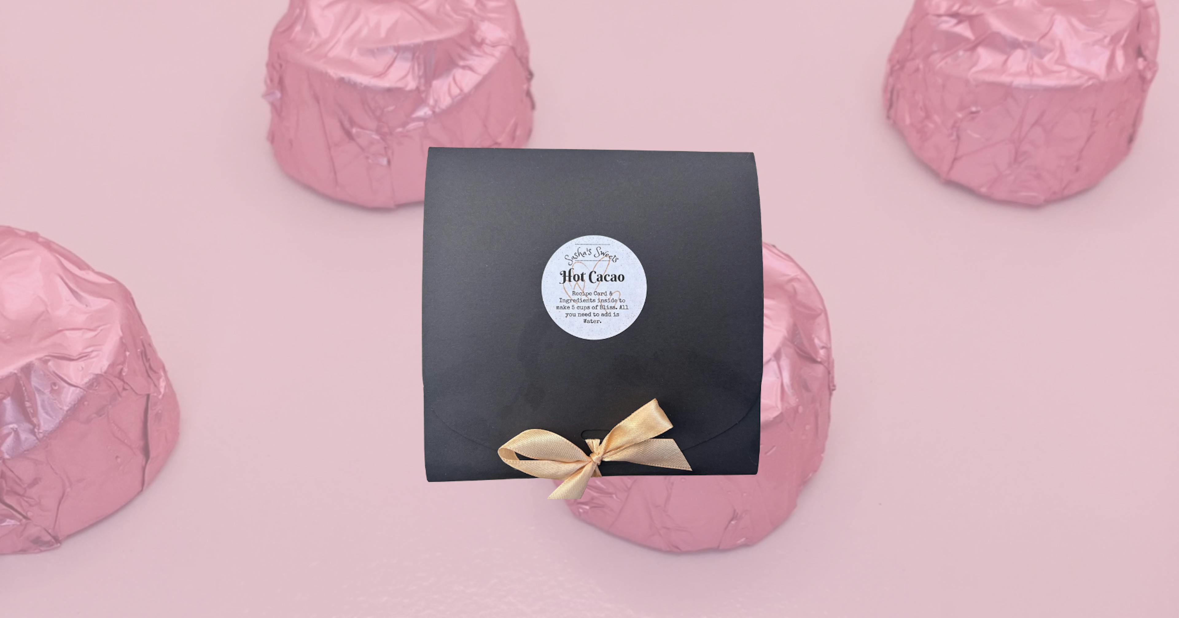 A box of chocolate on a pink background