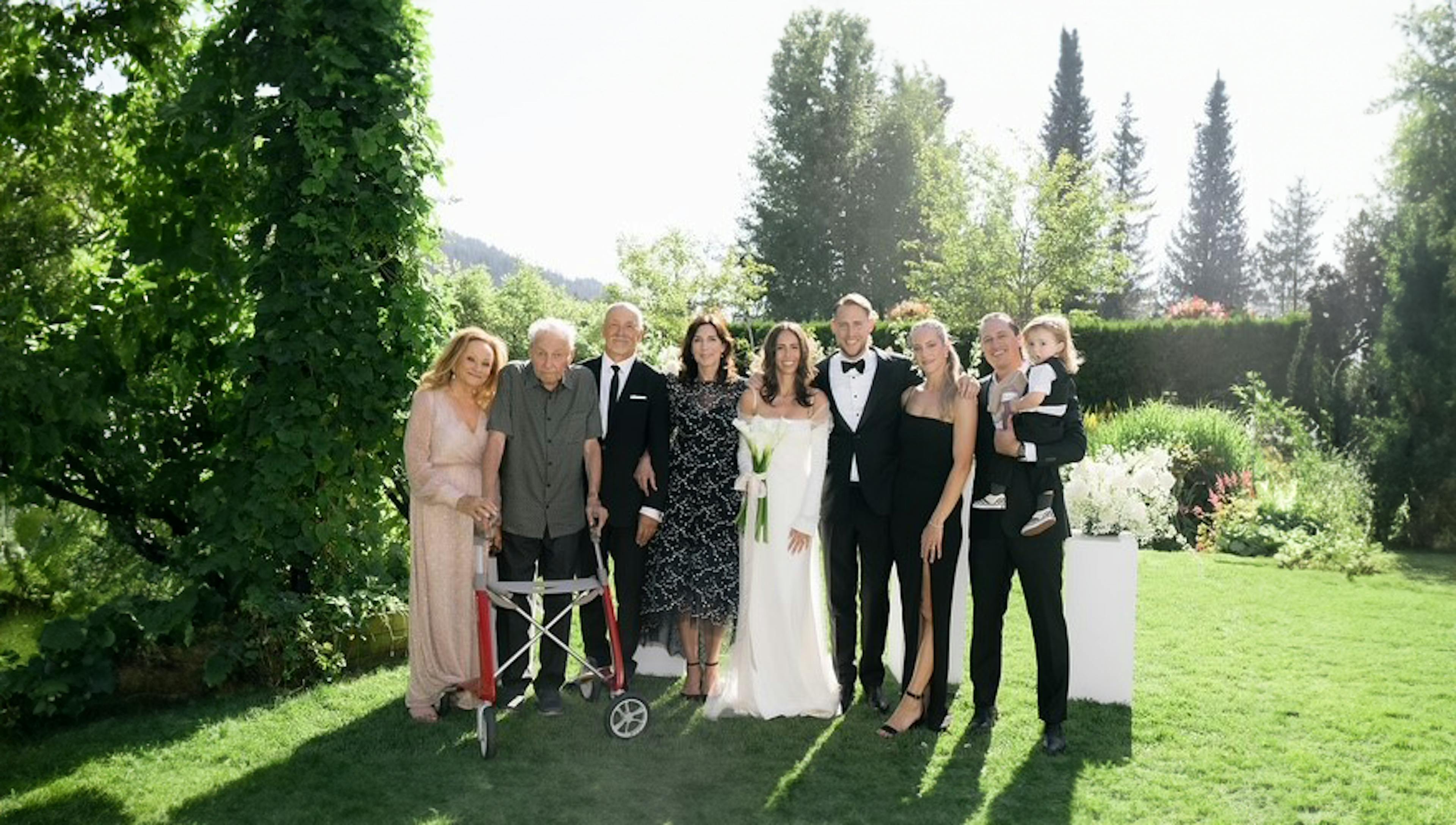 Three generations of the Trademan family pose at a family wedding. 