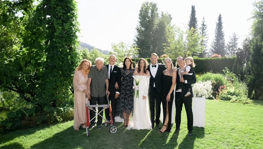 Three generations of the Trademan family pose at a family wedding.