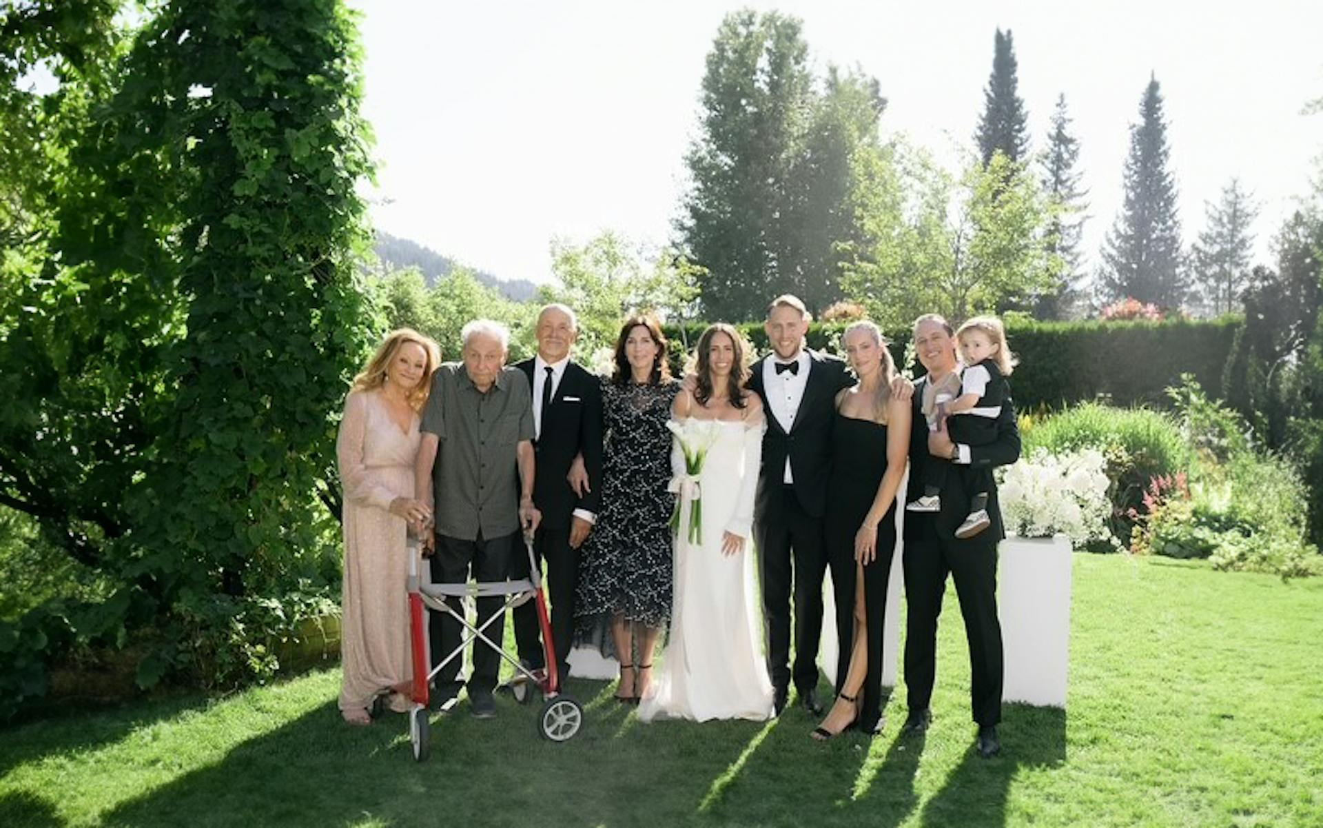 Three generations of the Trademan family pose at a family wedding. 