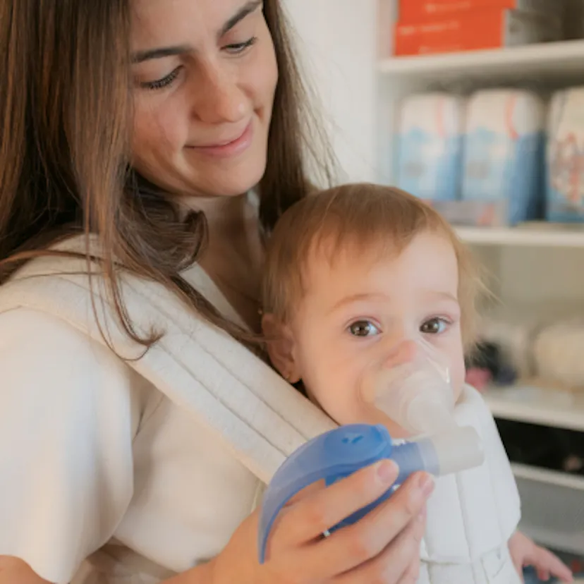 Baby Lucie at home with her mom, about to do a breathing treatment