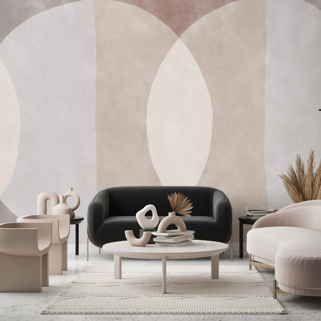 Un salle avec une table basse, deux canapés et un papier peint personnalisé avec des motifs couleurs pastels