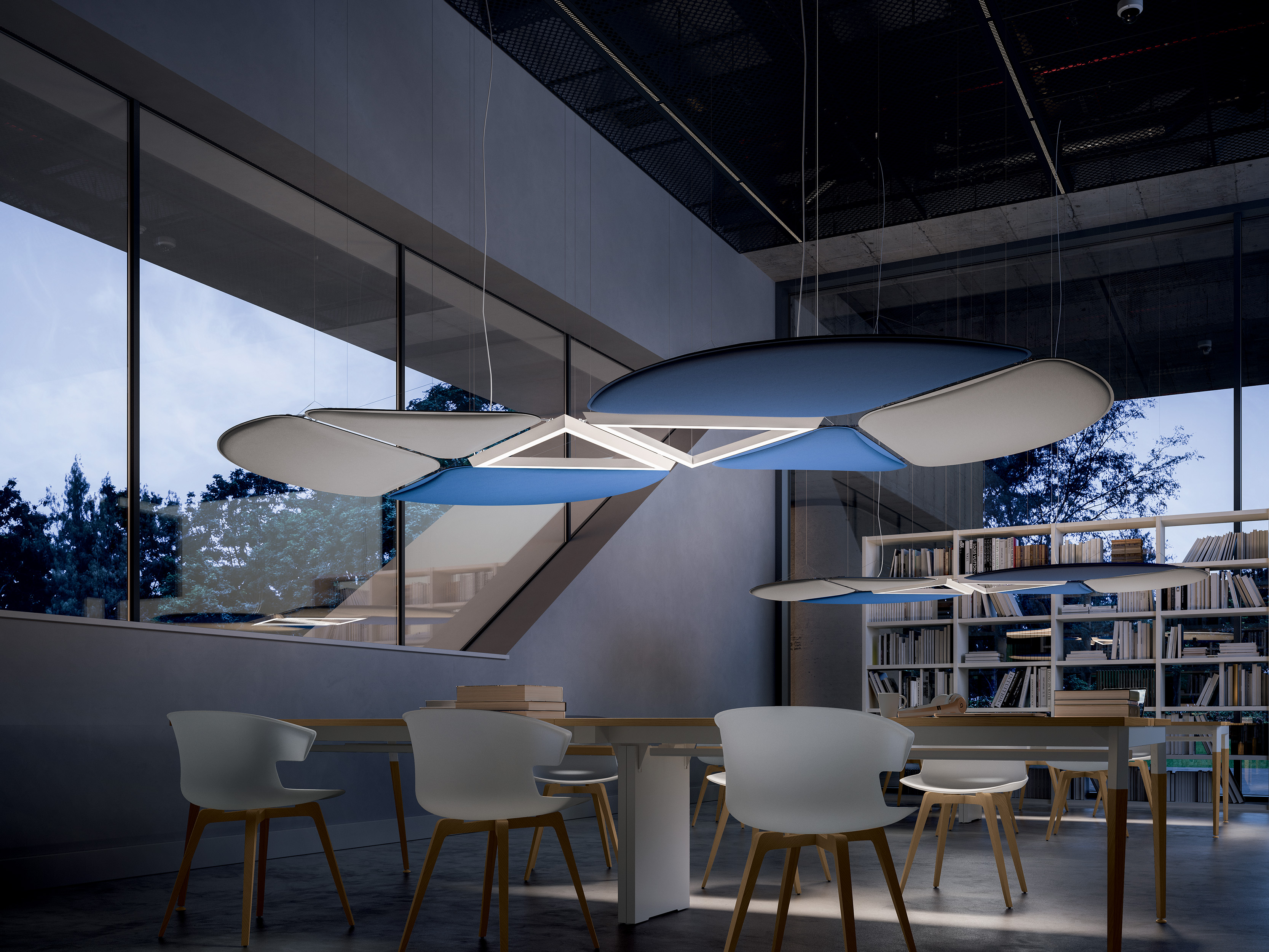 Grand salle avec une bibliothèque, une table et des chaises. Au dessus un système posé par Dacota pour l’acoustique de la pièce