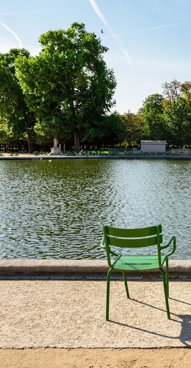 Sunny riverside in Paris with three chairs.