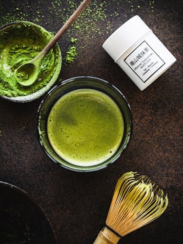 Matcha powder, green matcha tea liqueur and bamboo chasen whisk.