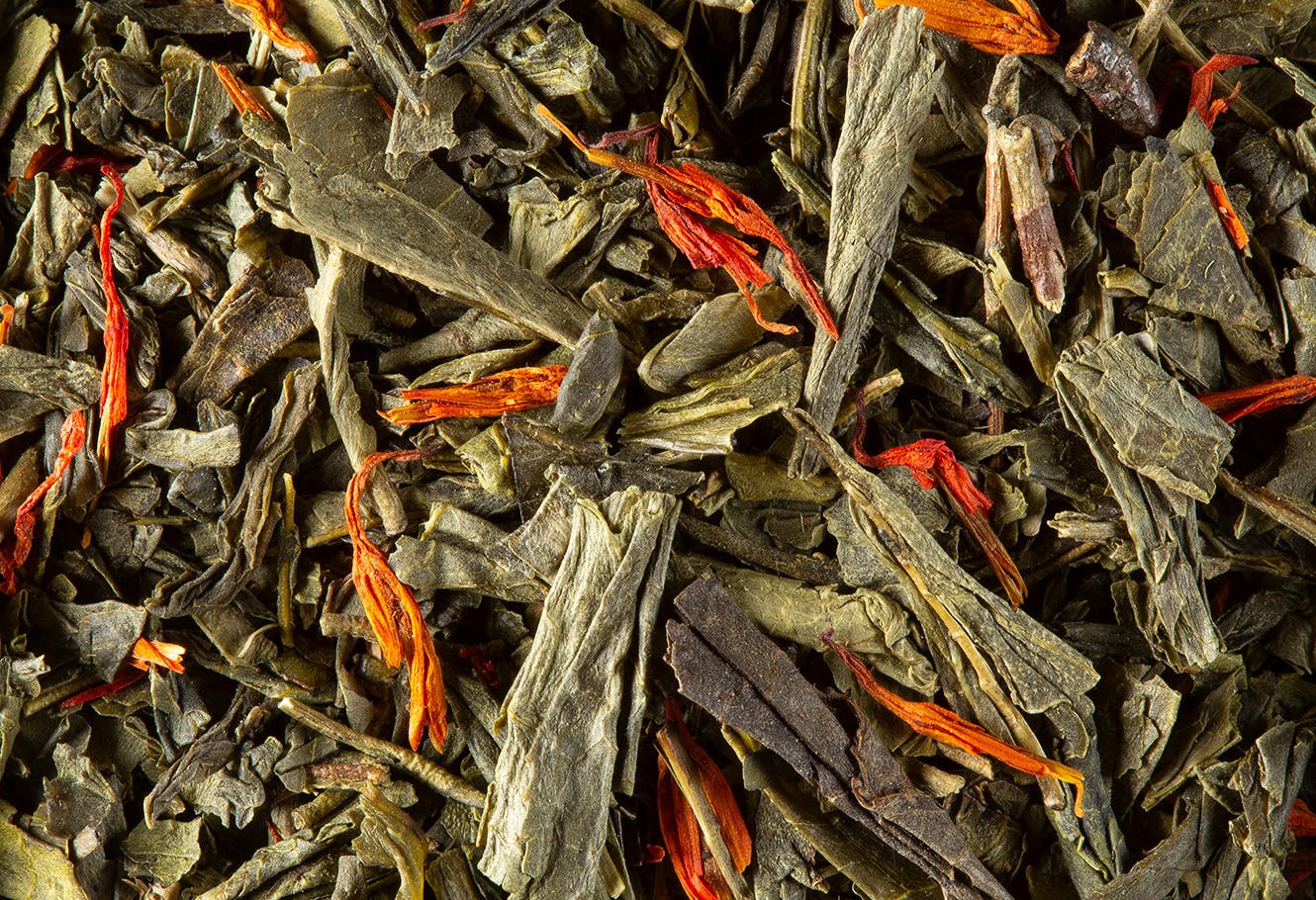 Flavoured green tea in bulk with flower petals.