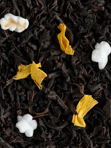 Flavoured black tea in bulk with flower petals and puffed rice.