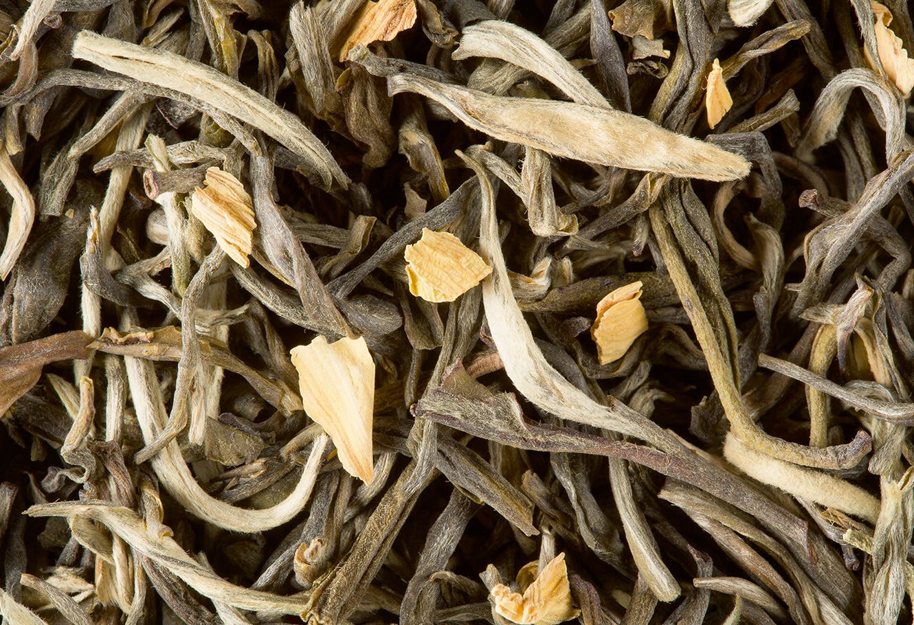 Flavoured white tea in bulk with flower petals.