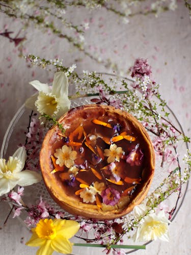 Pastry flan with white tea and flower jelly on a table