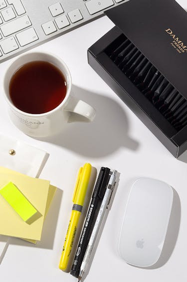 Mug of tea on a desk.