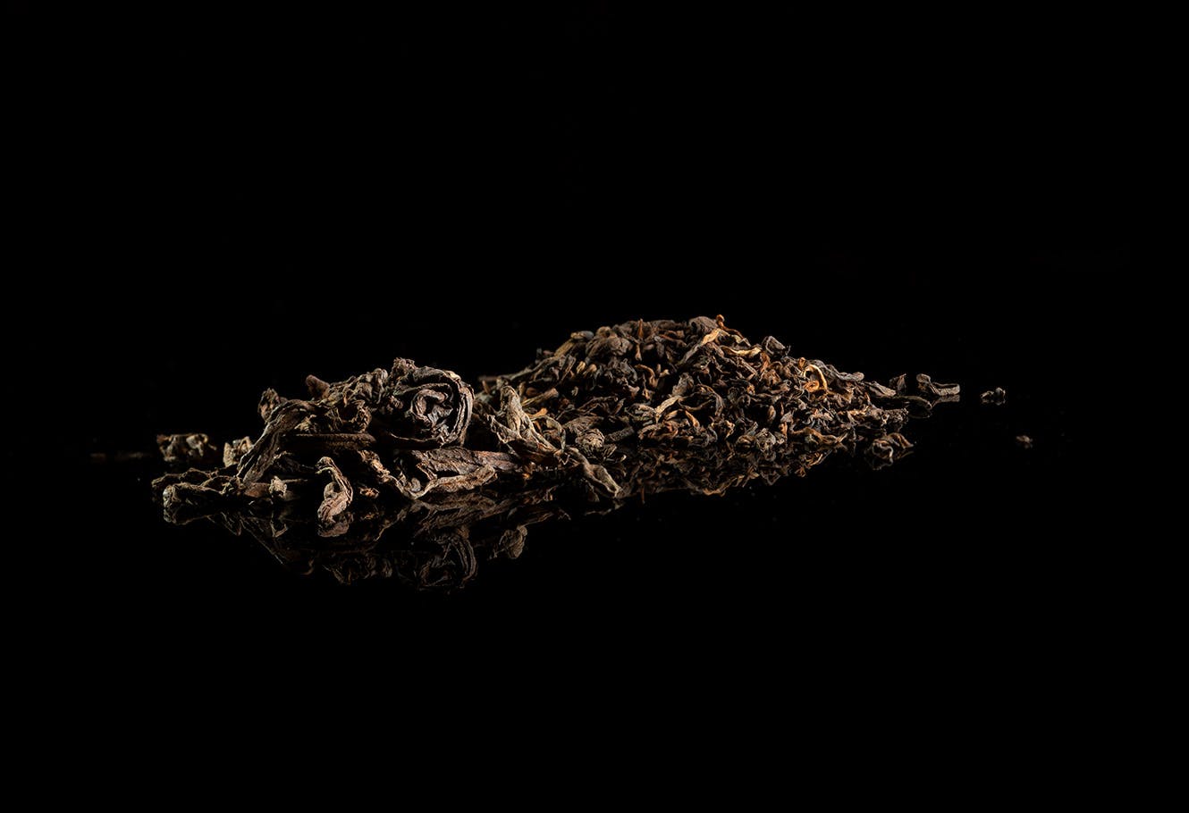 Dark tea leaves in bulk.