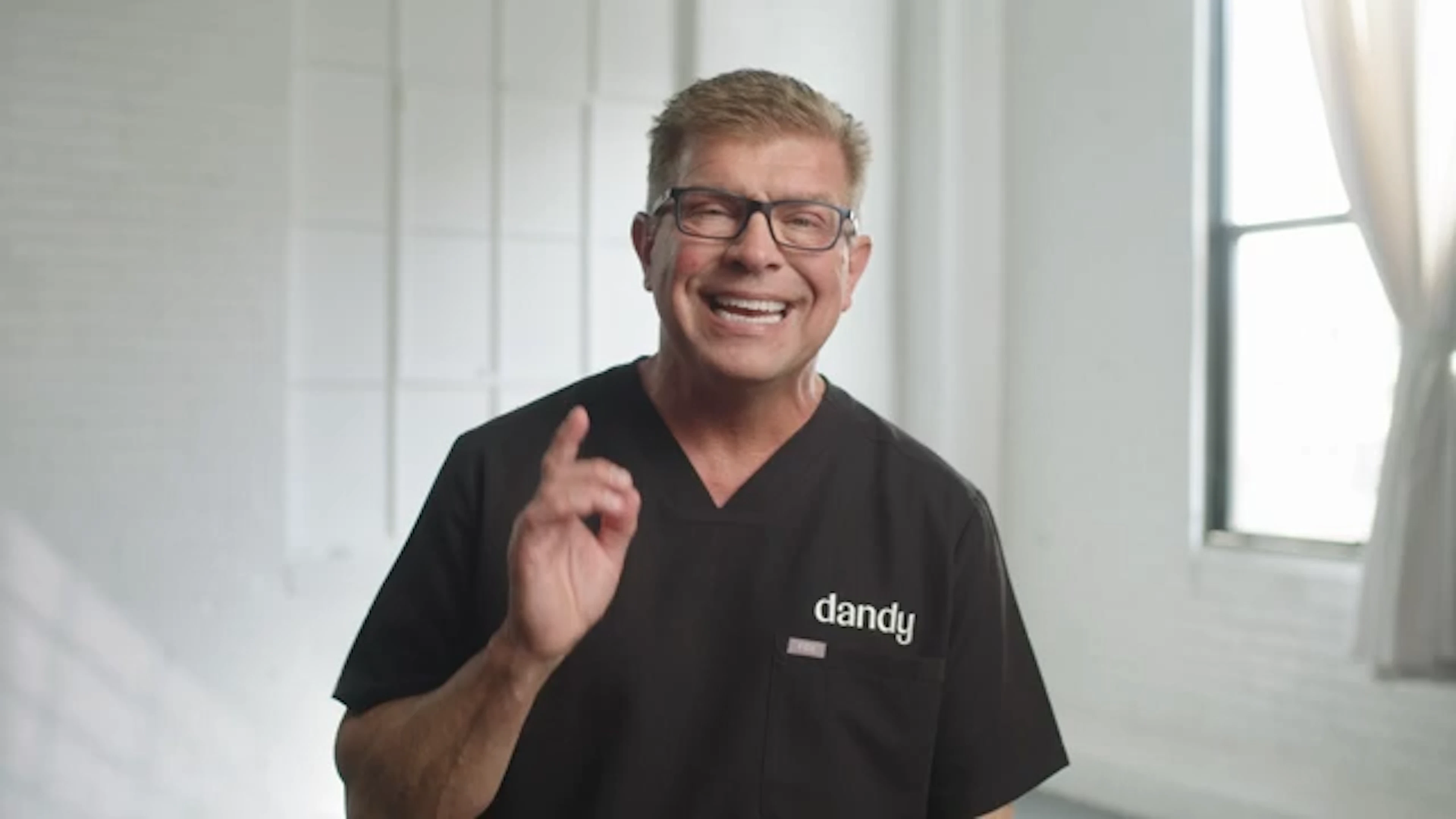 Dr. Barry Bartusiak smiling in a Dandy scrub top