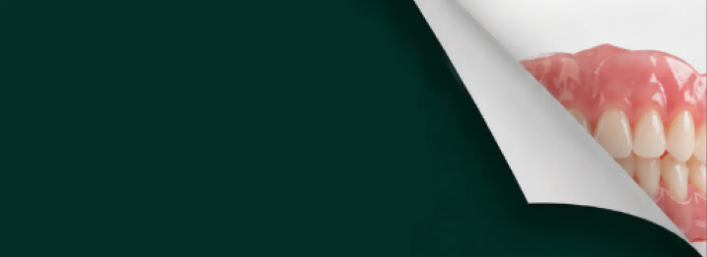 A page curling back to reveal a full denture on a dark teal background