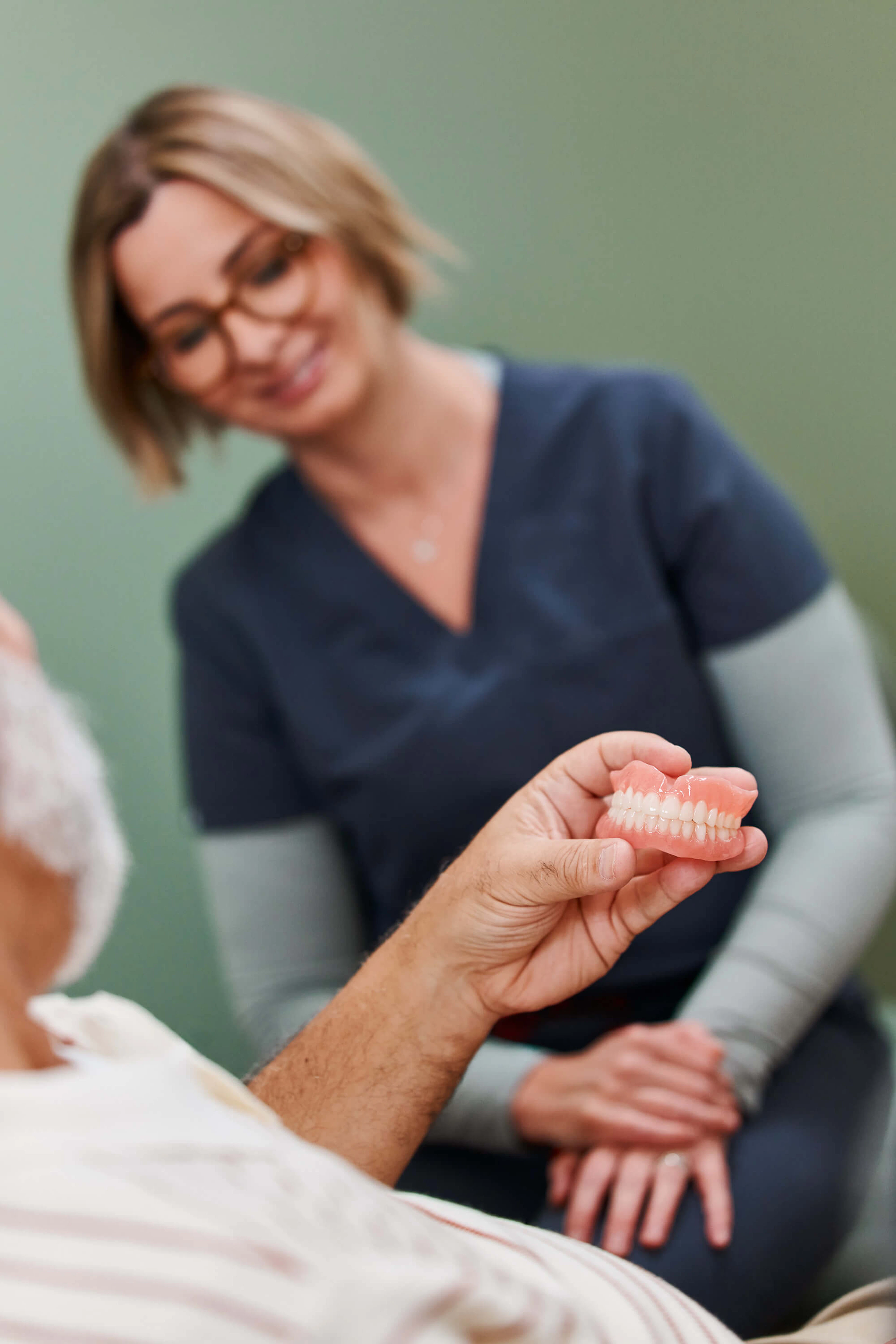 Patient and dentist looking at a Dandy Denture