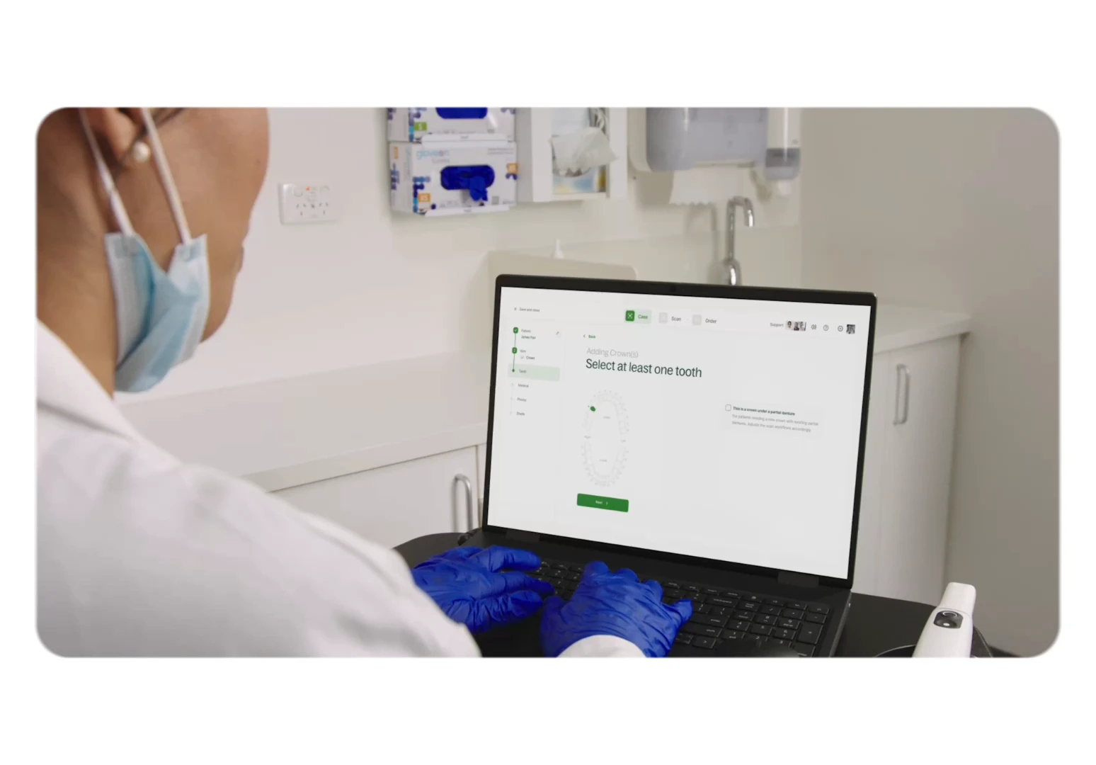 Dental professional reviewing a scan case on a laptop
