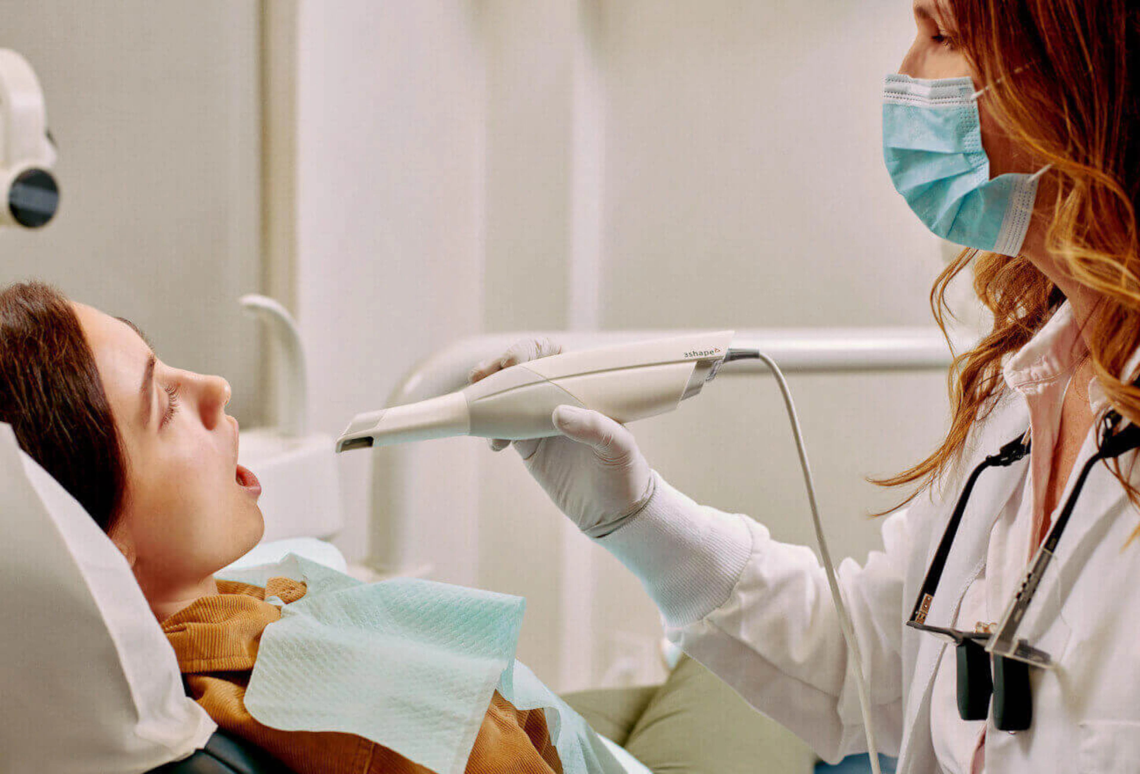 Dentist treating a patient with clinical support