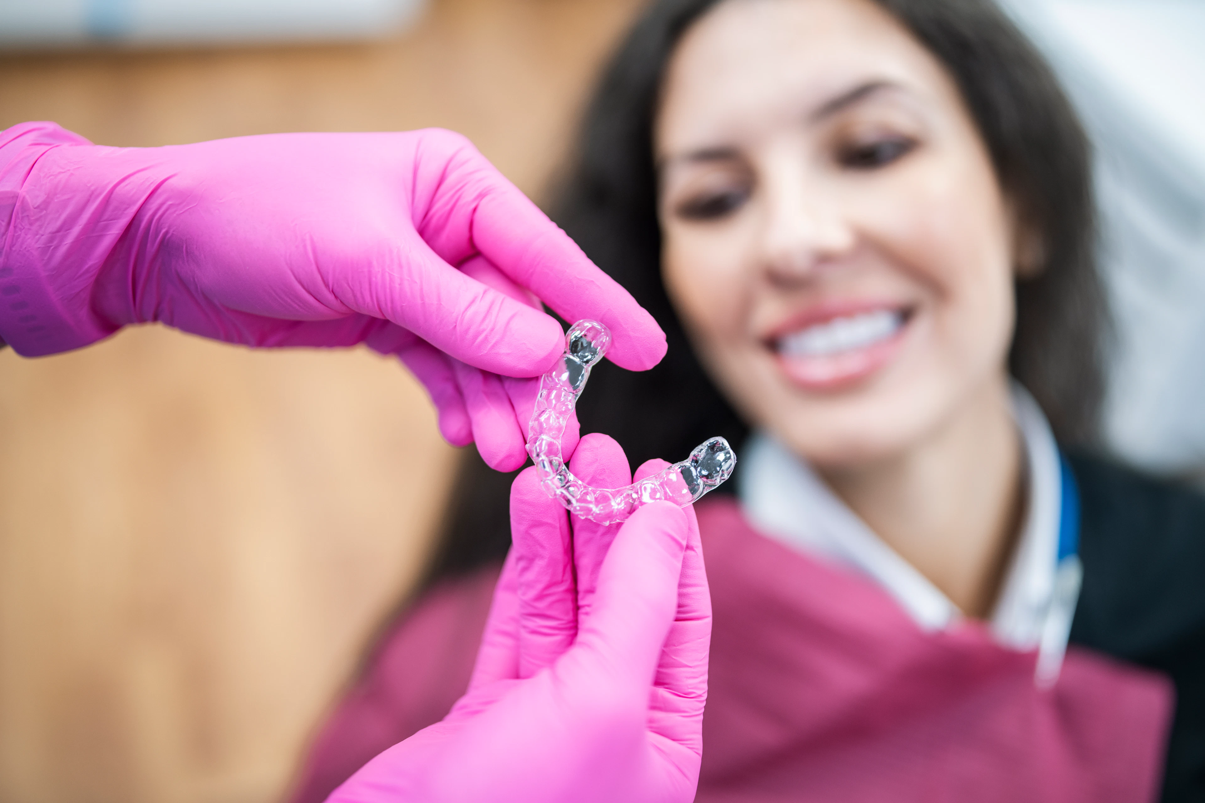 Orthodontist giving a happy patient dental aligners.