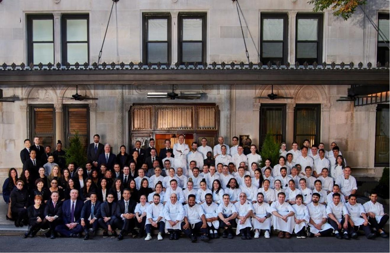 Group photo of staff in front of Restaurant Daniel