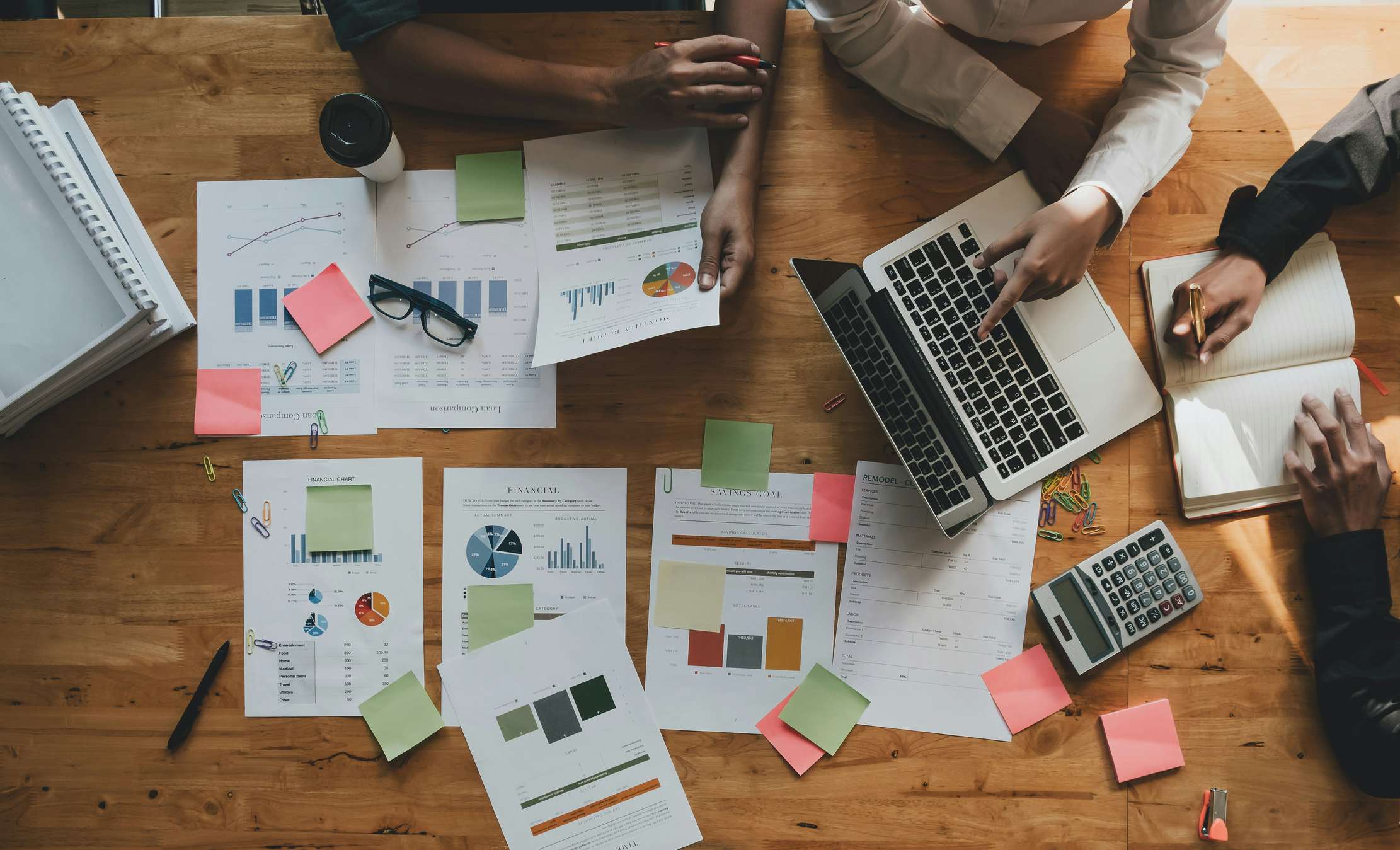 A group of people huddled around papers talking about their new business