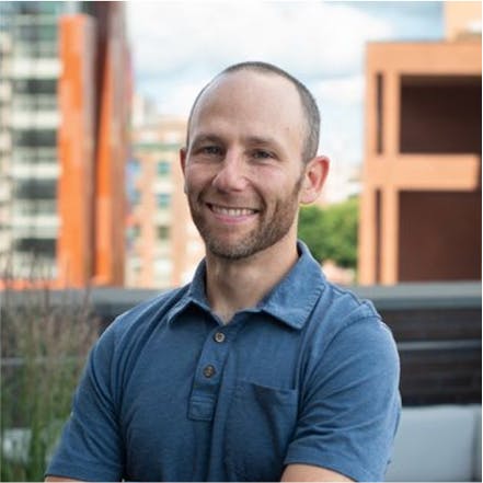 Photo of Ryan Juliano, outdoors, with a friendly smile, wearing a short-sleeve blue polo shirt