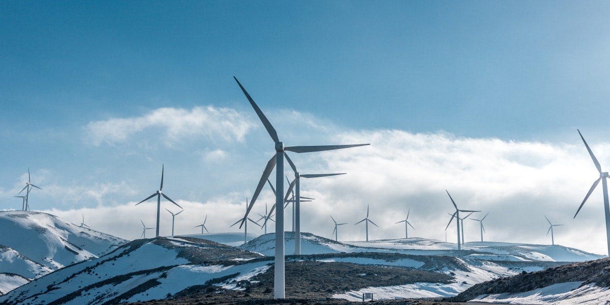 Wind turbine farm on mountains in the snow