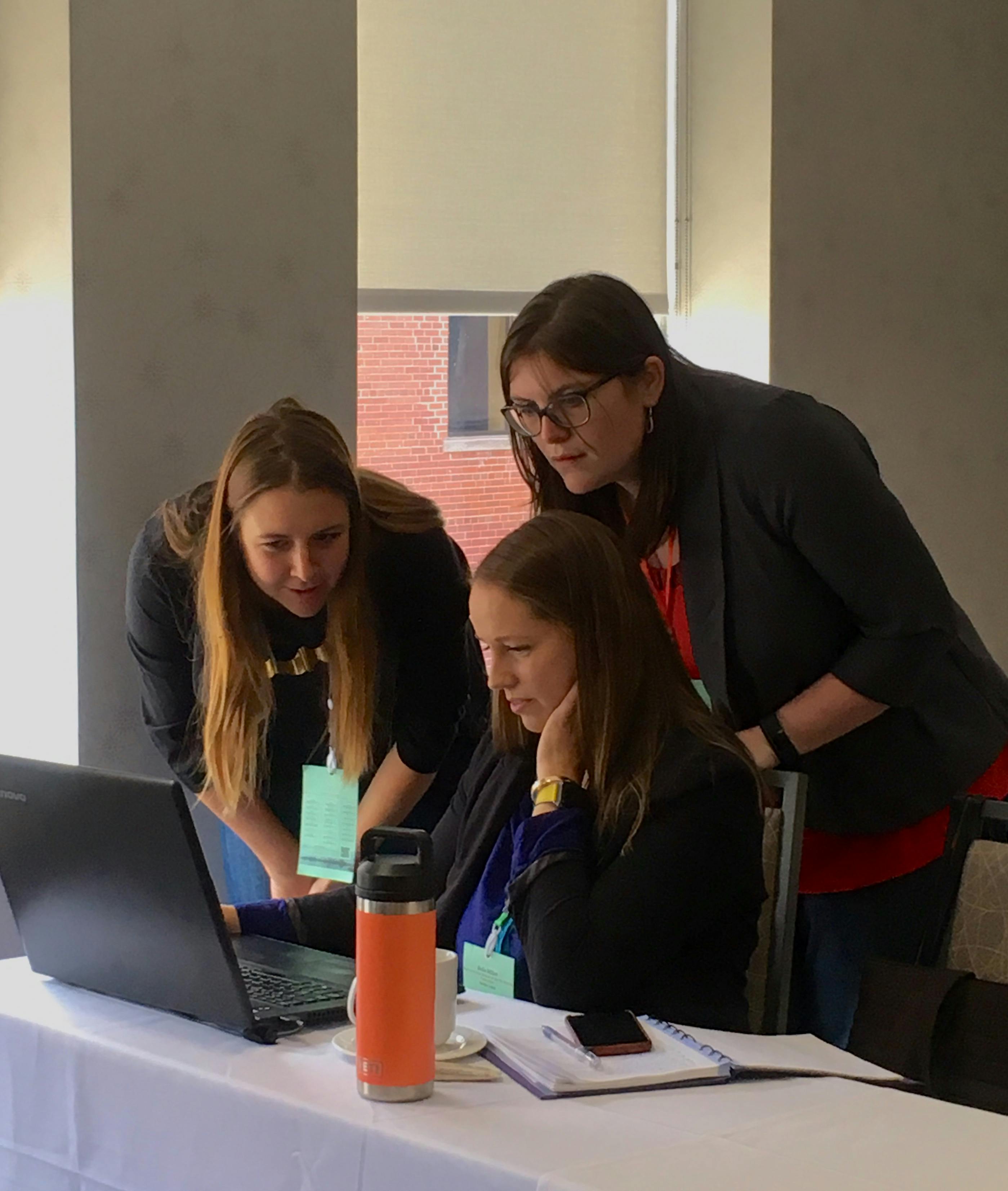 Chelsea and Emma assist a datathon participant
