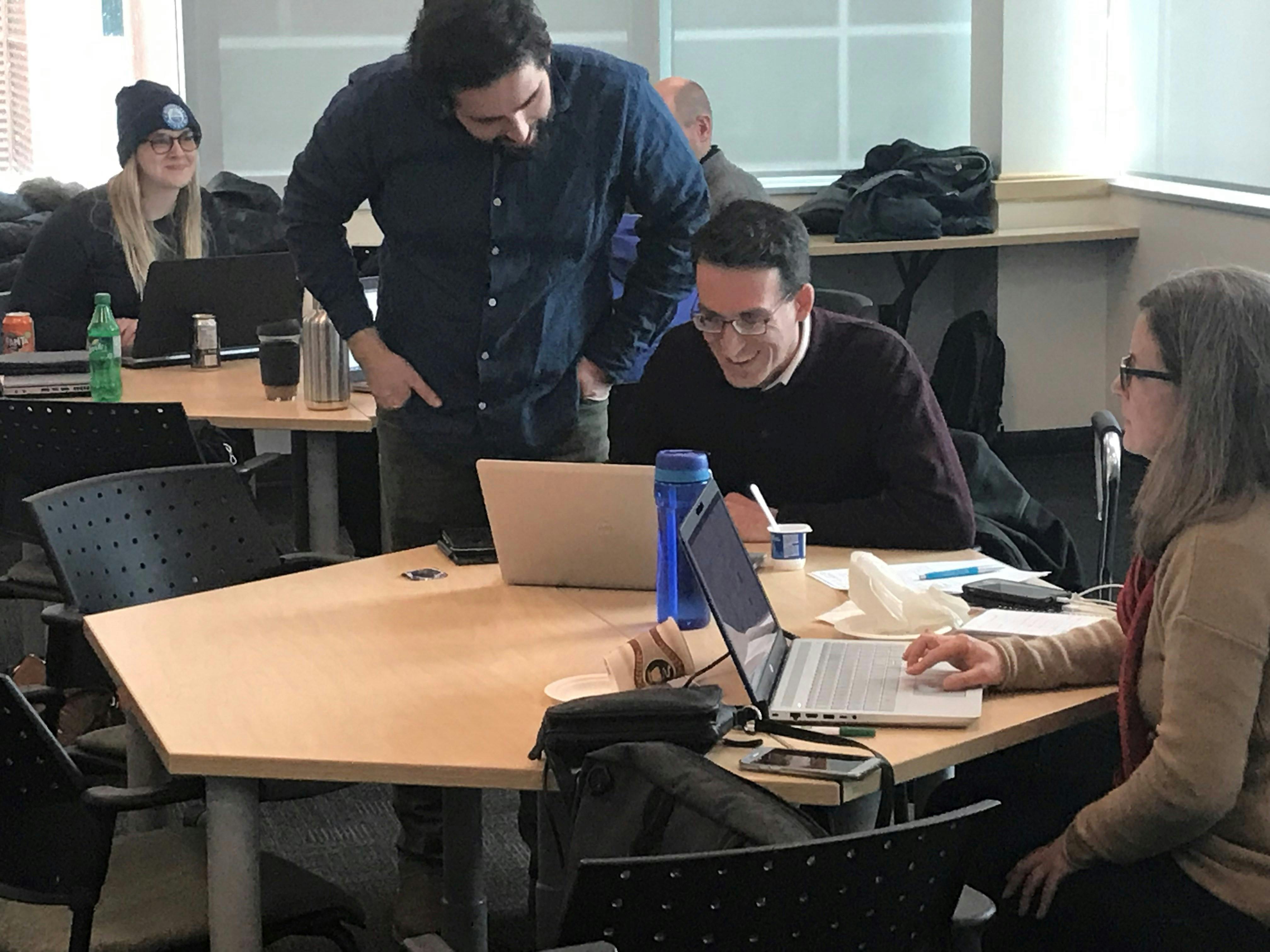 Patrick LeClair reviewing data with Cameron Deacoff at a laptop on a table