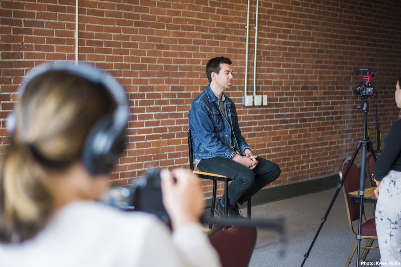 Donald Killorn of Eastern Charlotte Waterways sitting on a chair as he is being filmed during an interview