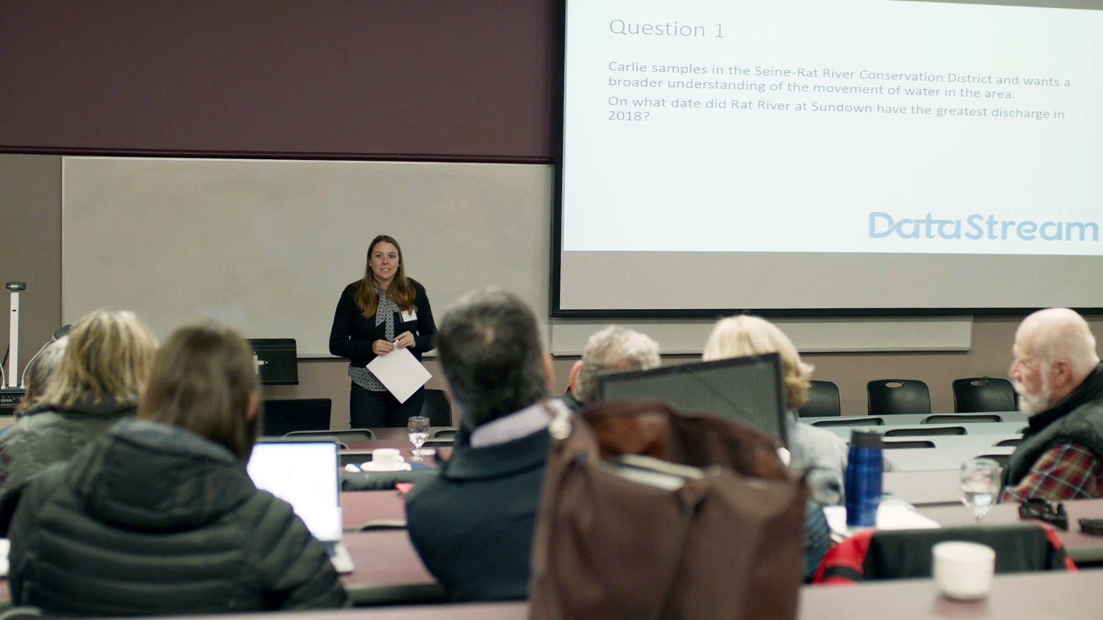Chelsea Lobson presenting a datathon to a group at the Lake Winnipeg gathering